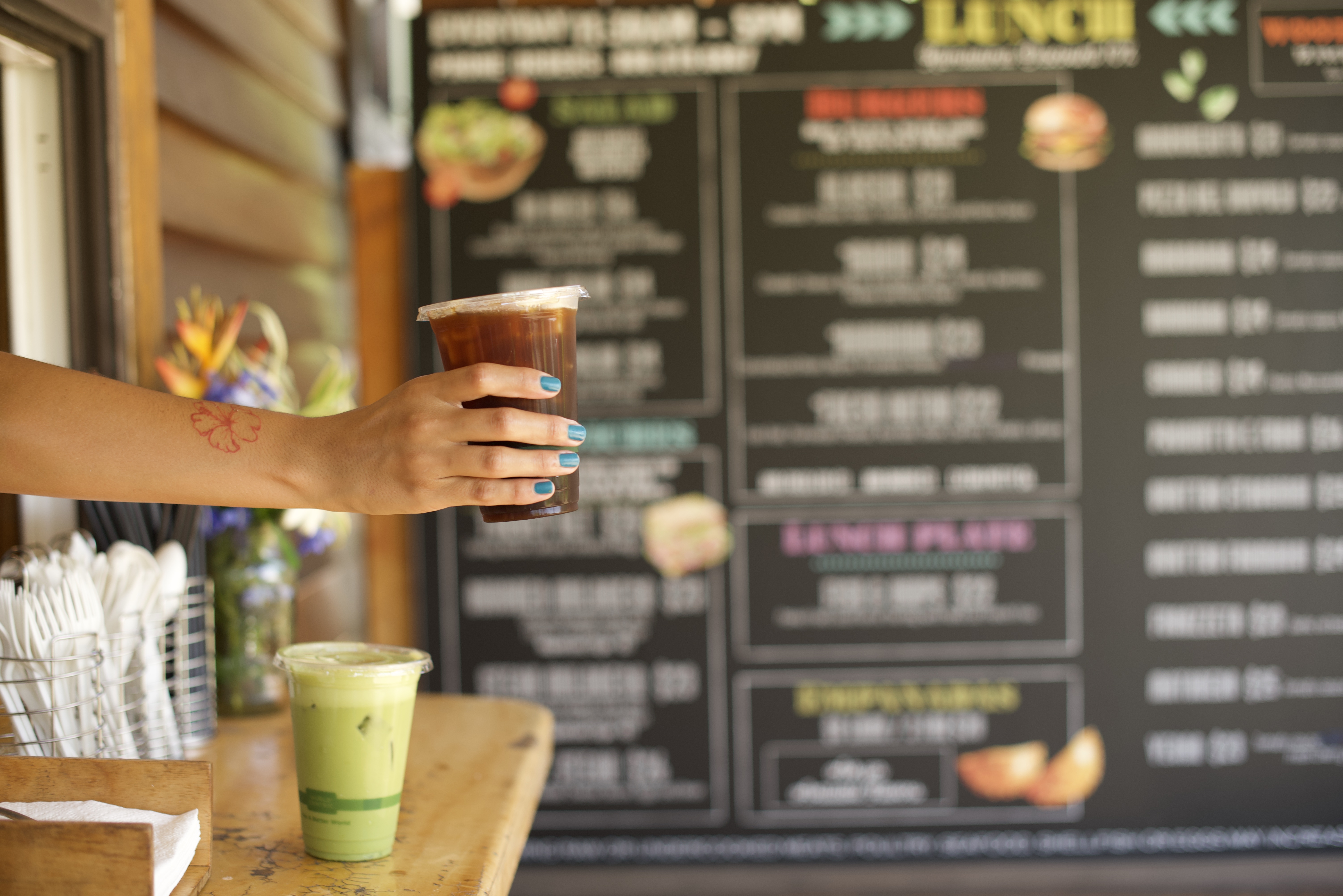 a hand holding a cup of coffee