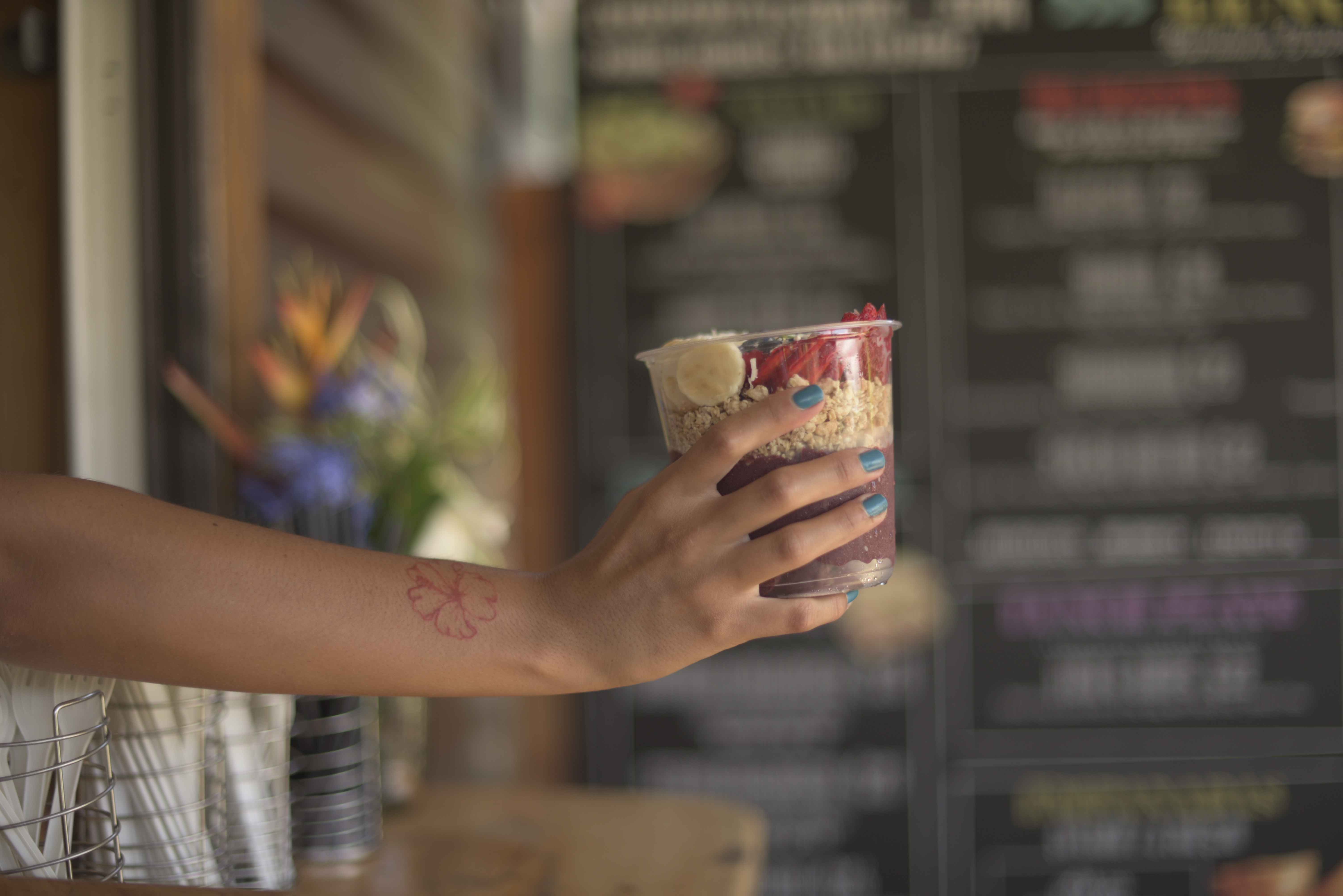 a hand holding a cup of food