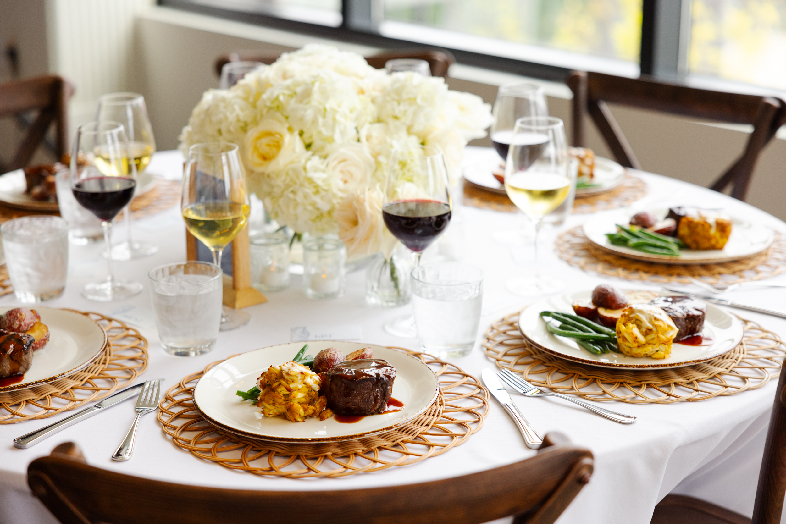 a group of people sitting at a table with a plate of food