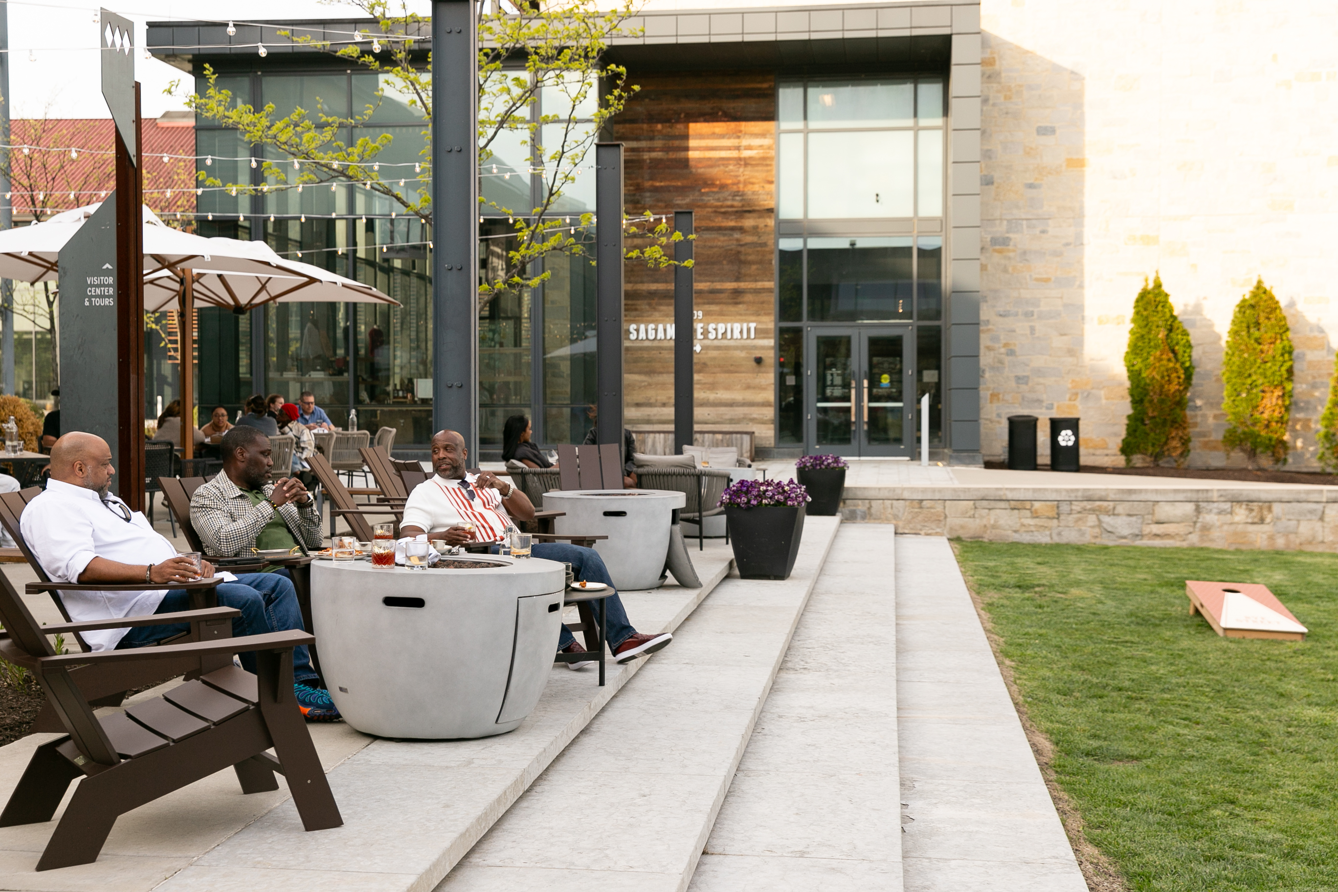 a group of people sitting at a table in front of a building