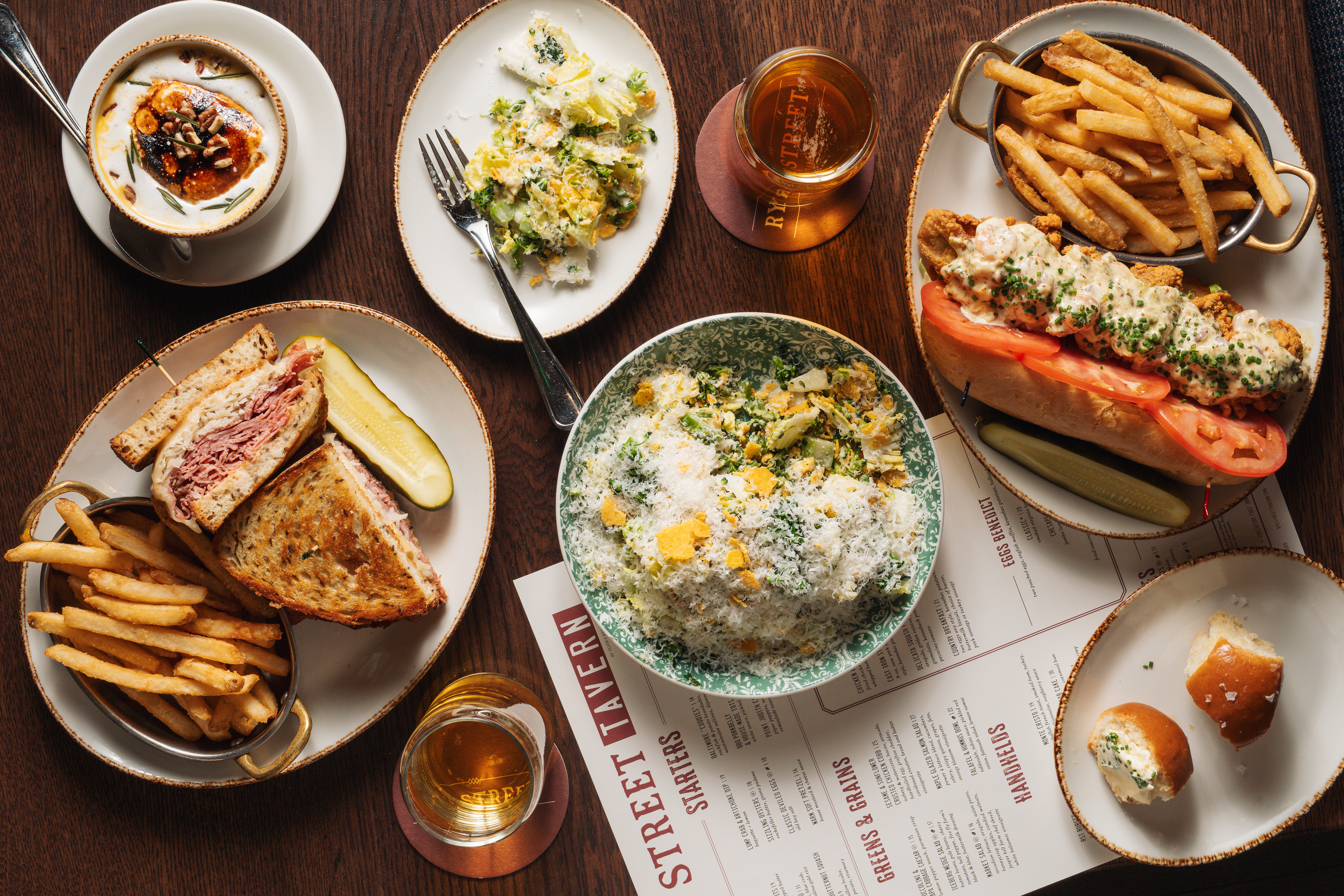 a table with plates of food and drinks