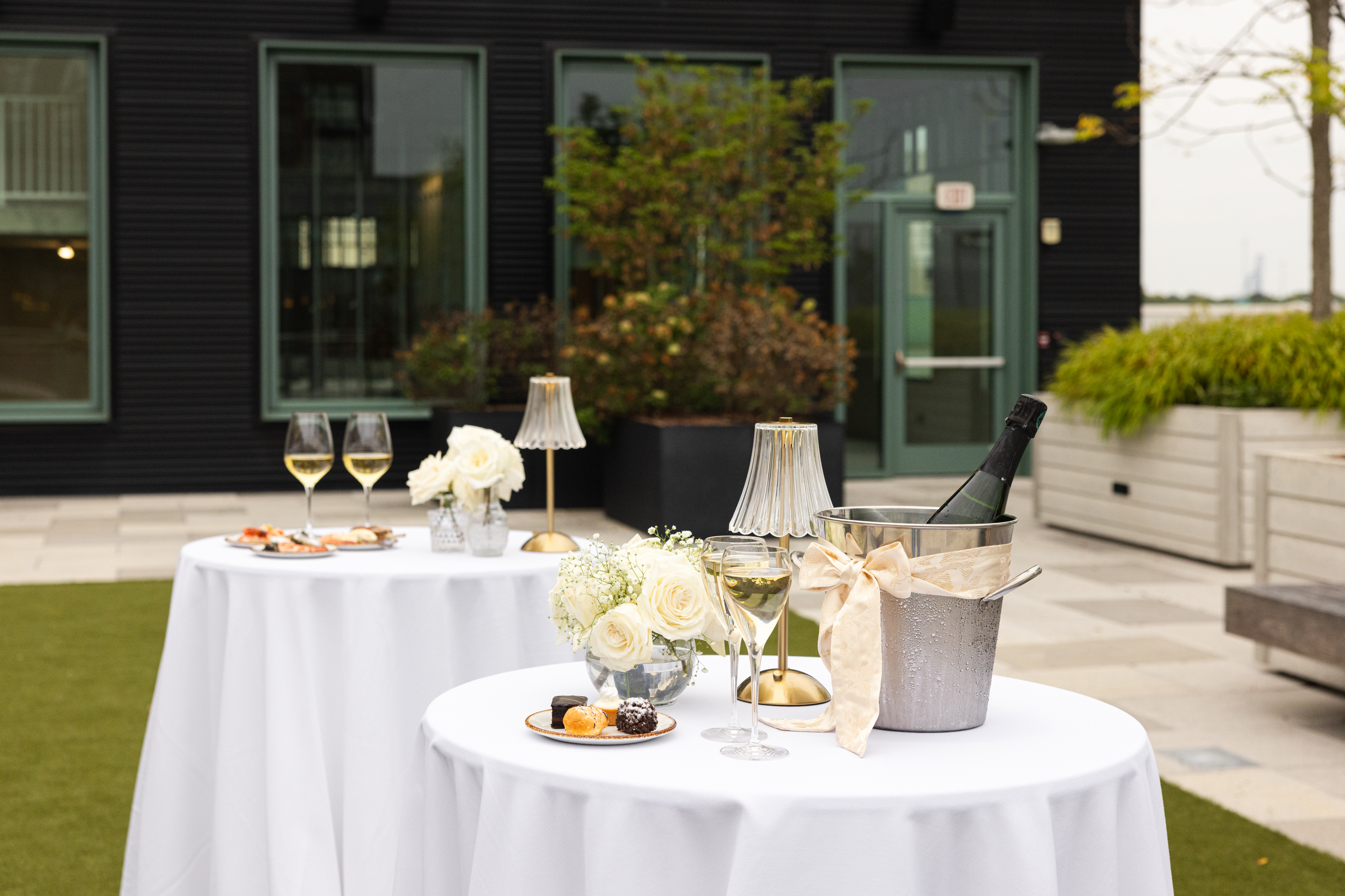a person sitting at a table in front of a wedding cake