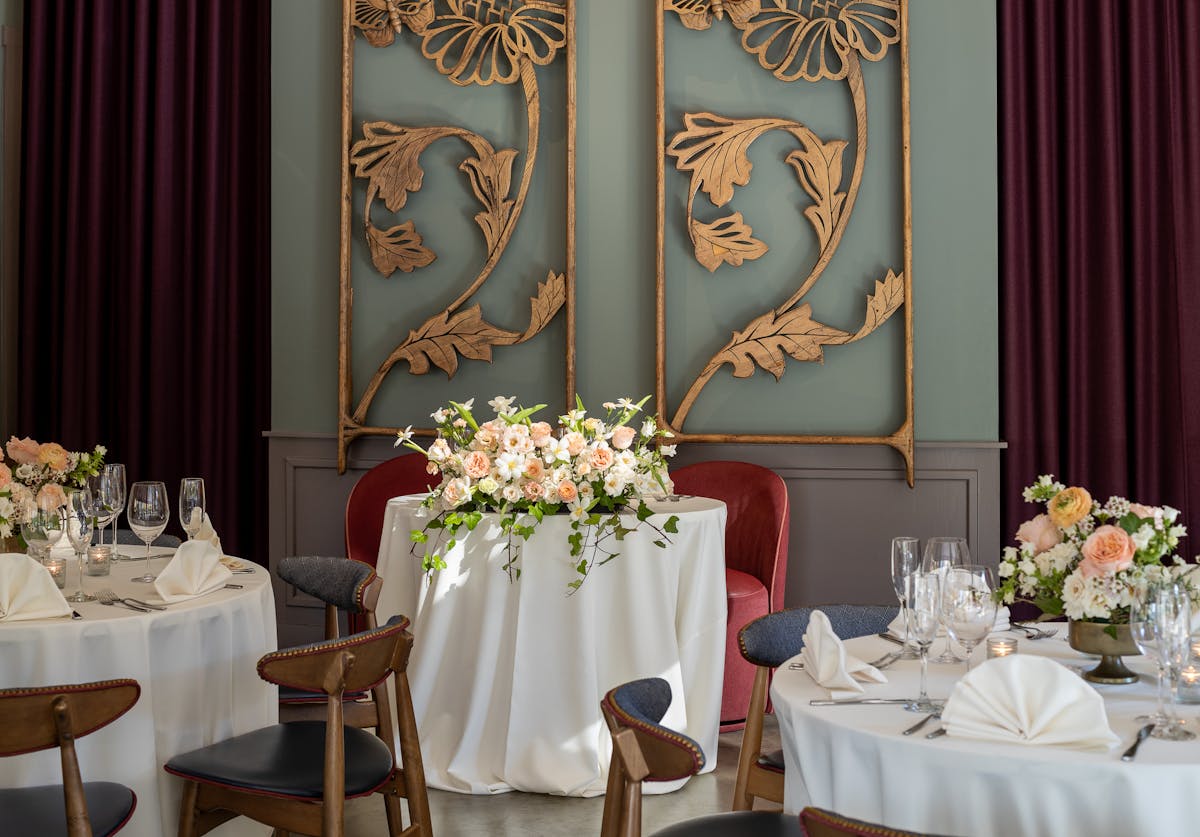 a room filled with furniture and vase of flowers on a table