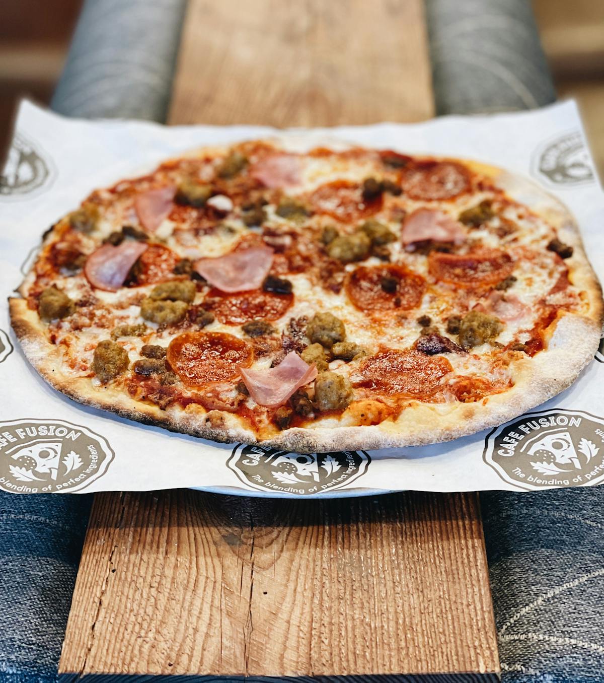 a pizza sitting on top of a wooden table