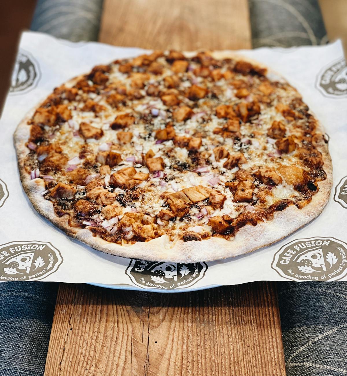 a slice of pizza sitting on top of a cutting board with a cake