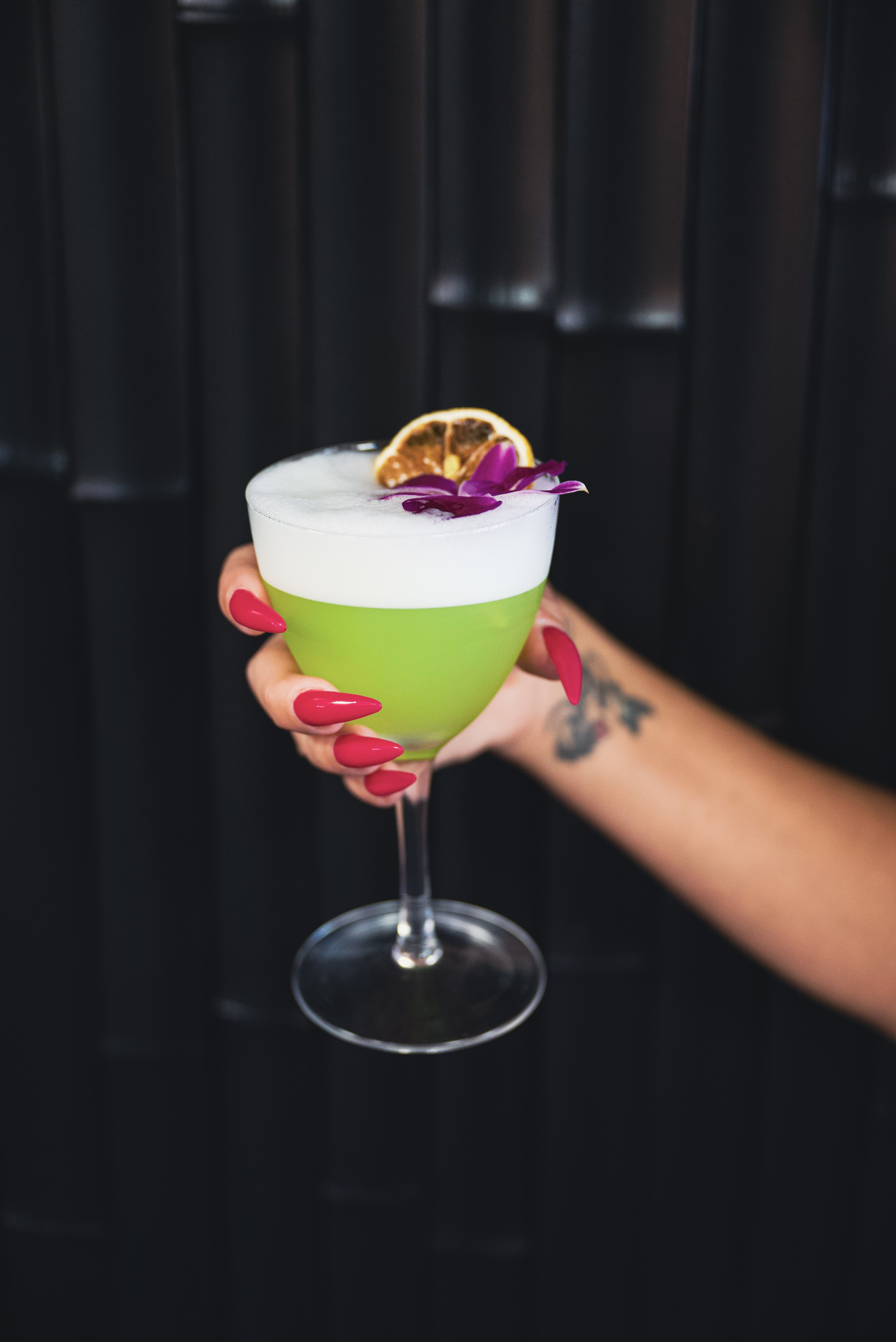 a hand holding a glass of drink