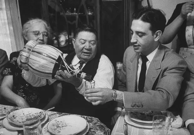a group of people sitting at a table eating food