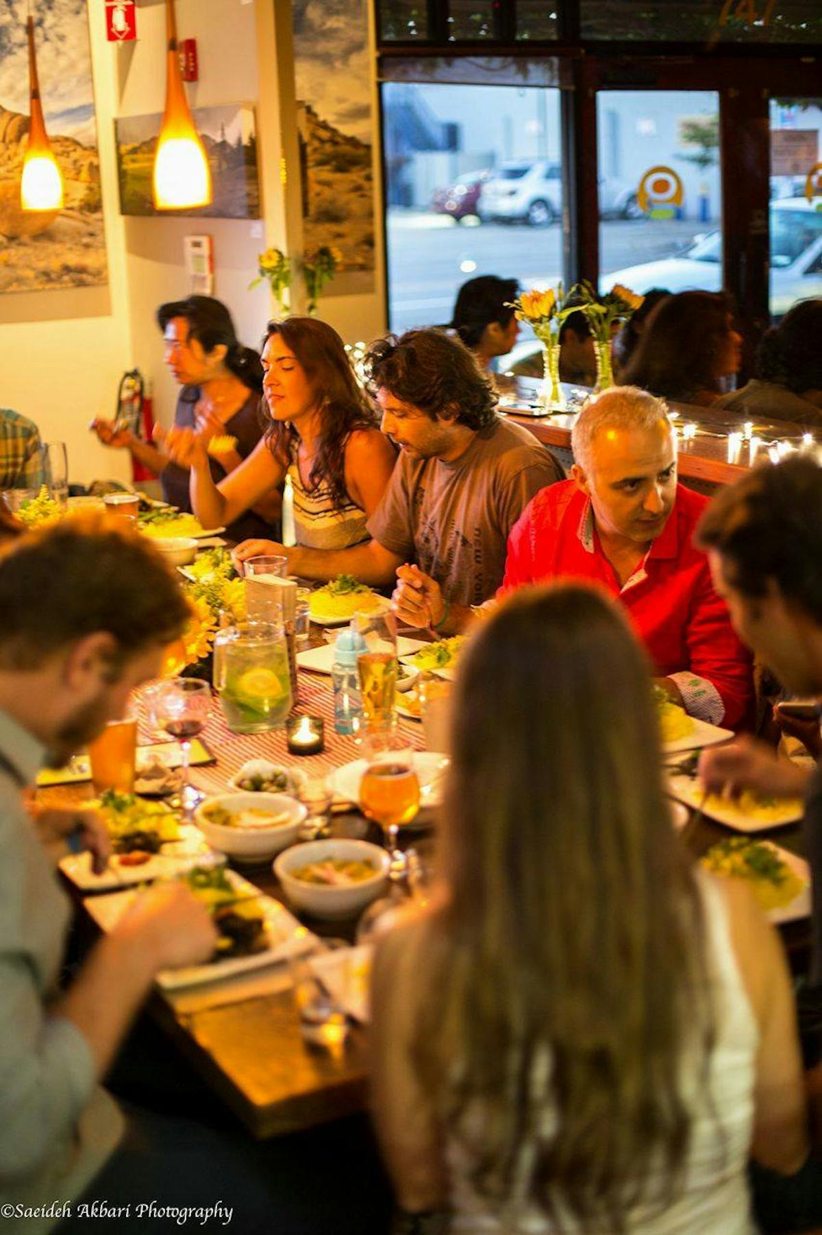 a group of people sitting at a table in a restaurant