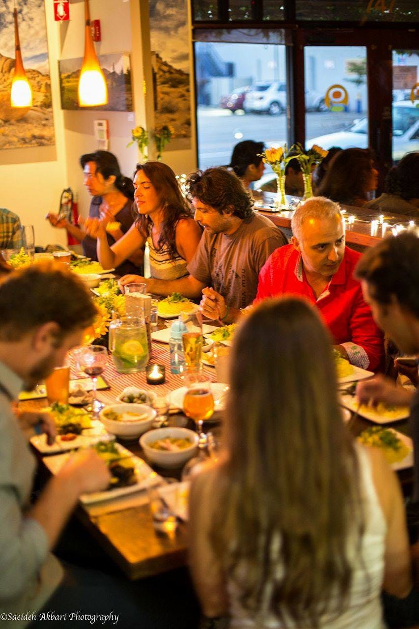 a group of people sitting at a table in a restaurant