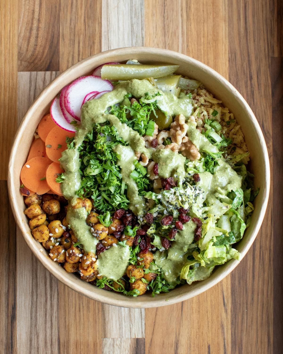 a bowl of broccoli sitting on top of a wooden table