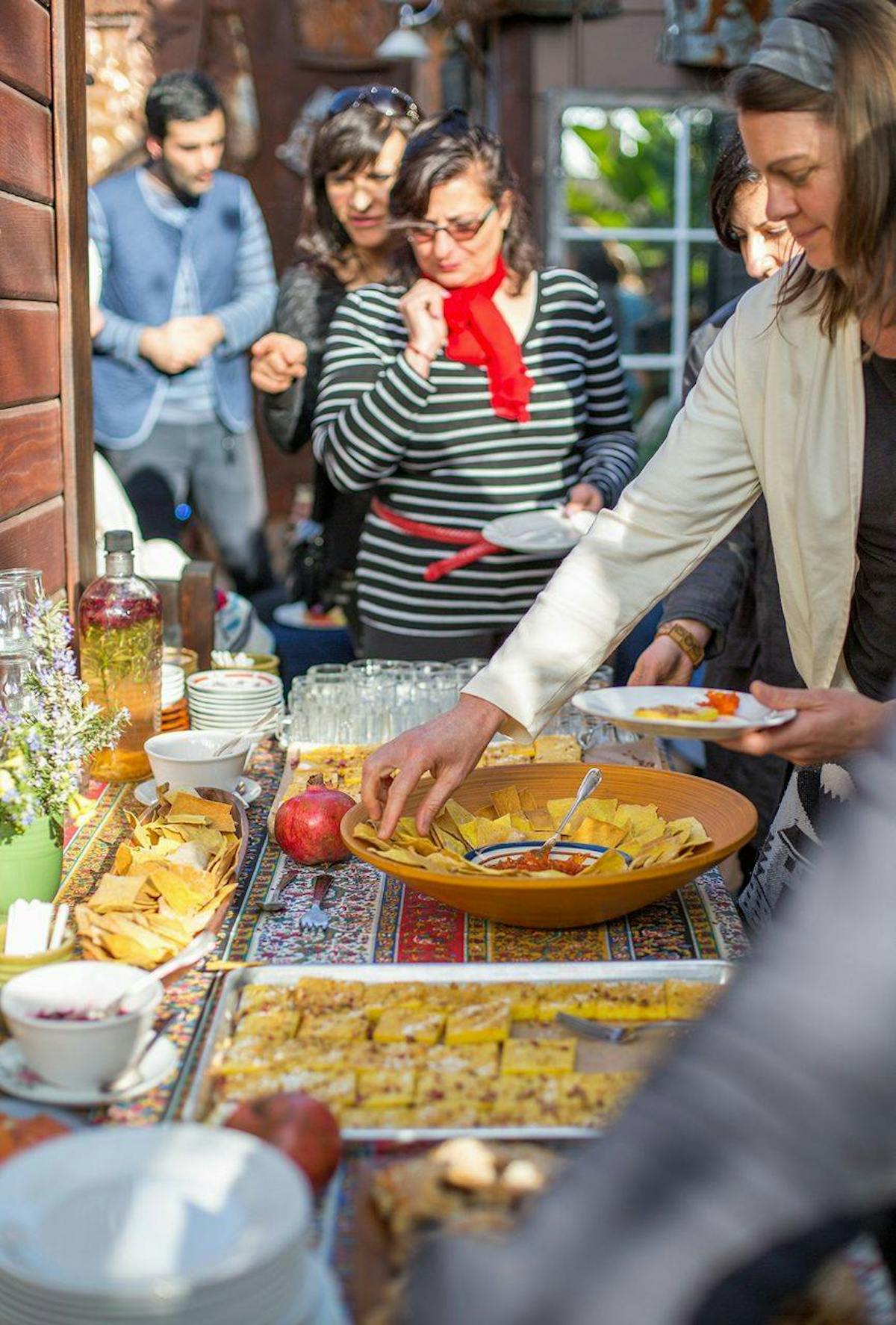 a group of people preparing food on a table