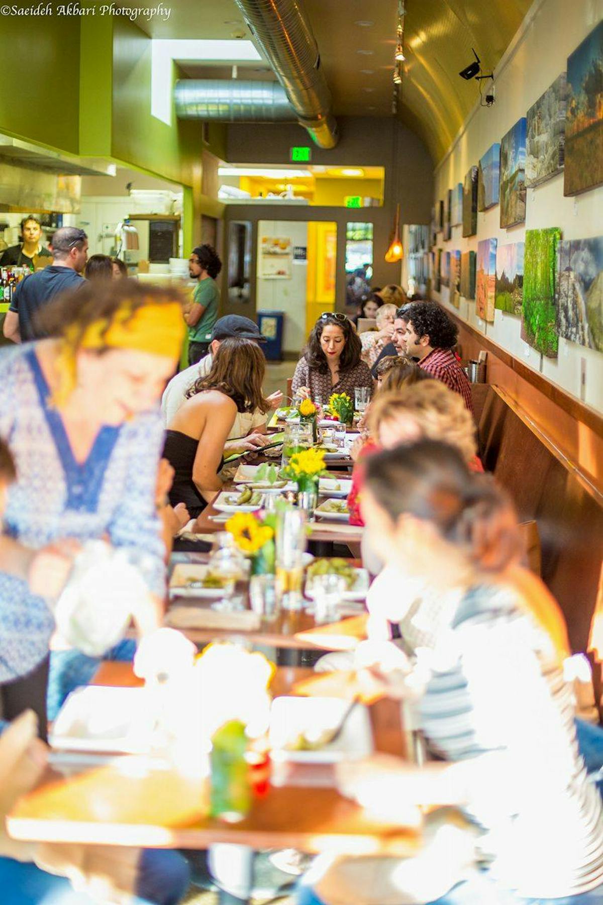 a group of people sitting at a table in a restaurant