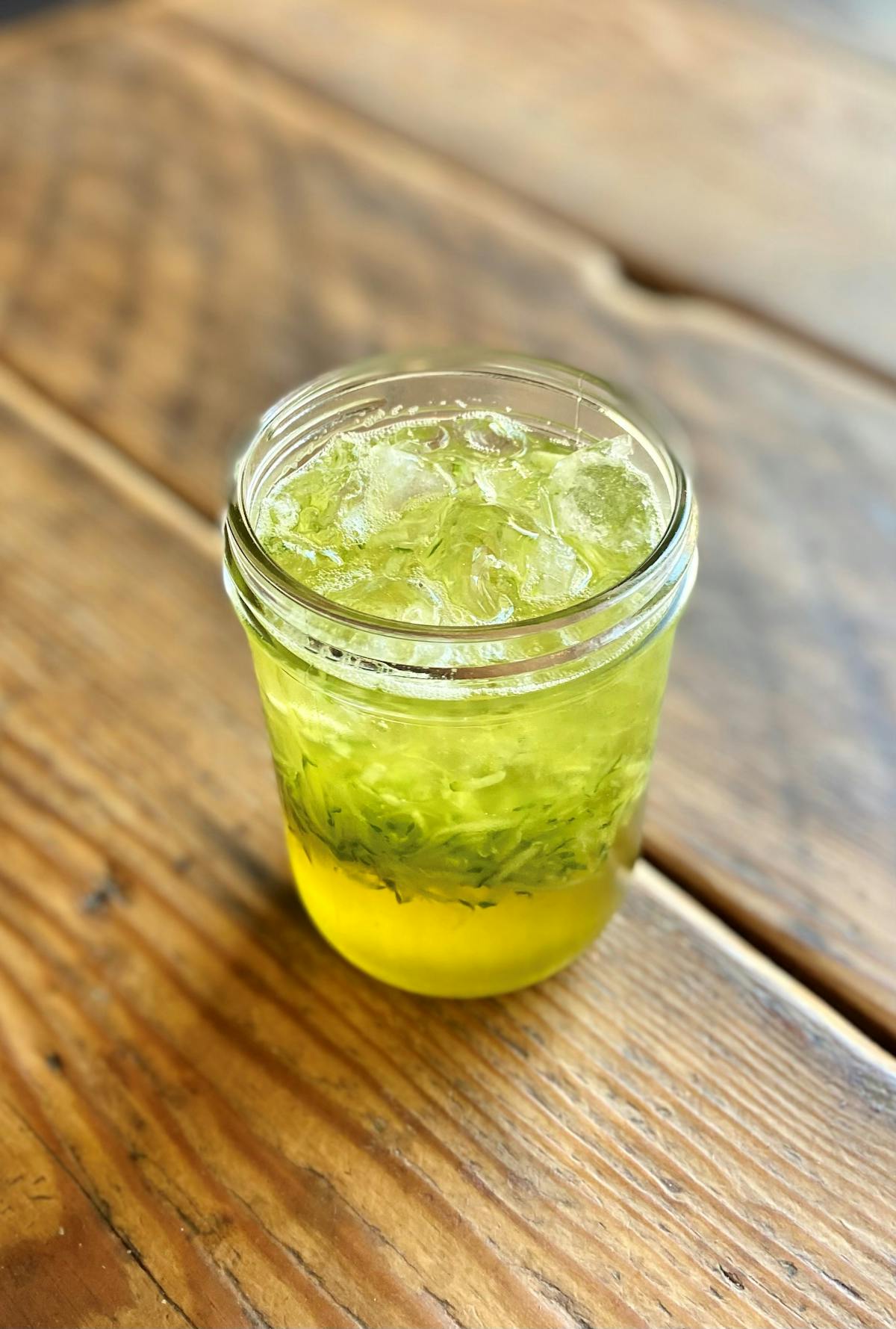 a close up of a glass cup on a wooden table