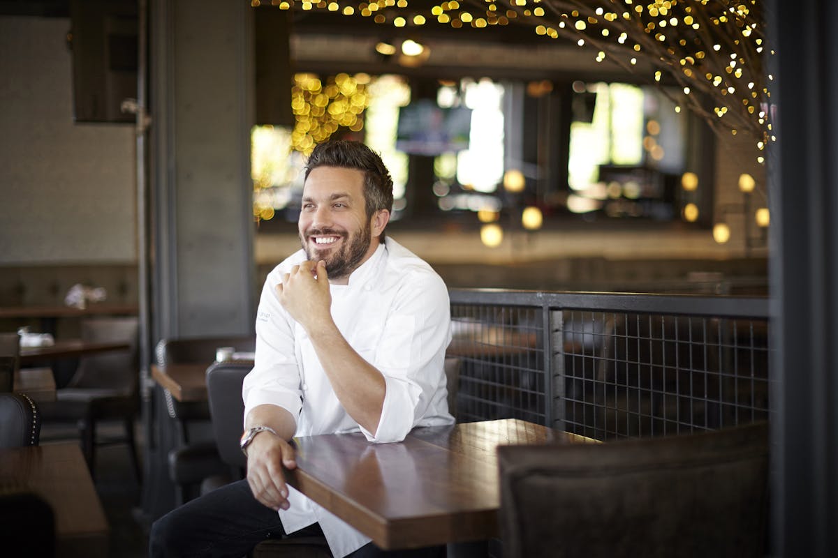 Fabio Viviani sitting in a chair talking on the phone