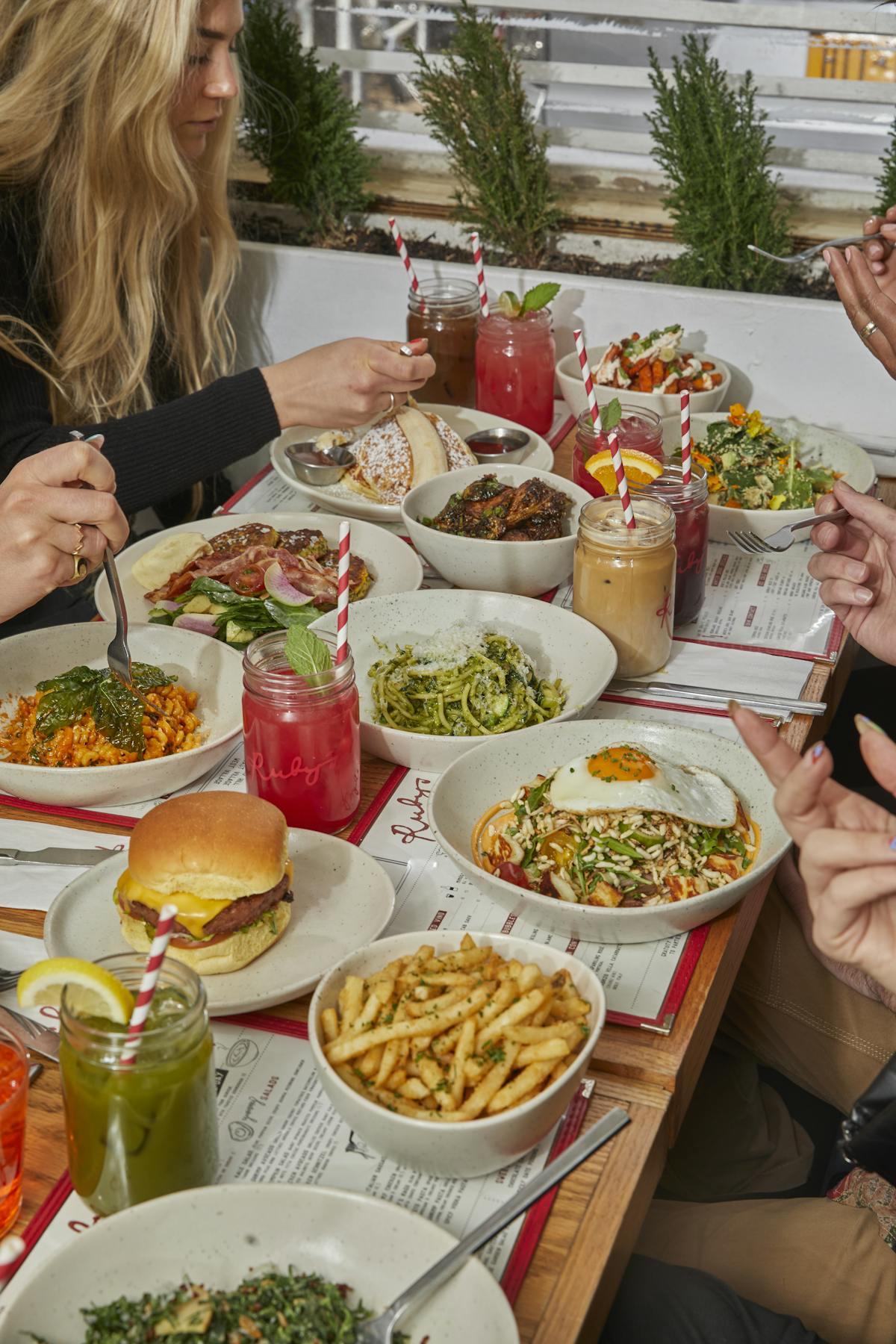 a woman sitting at a table with a plate of food