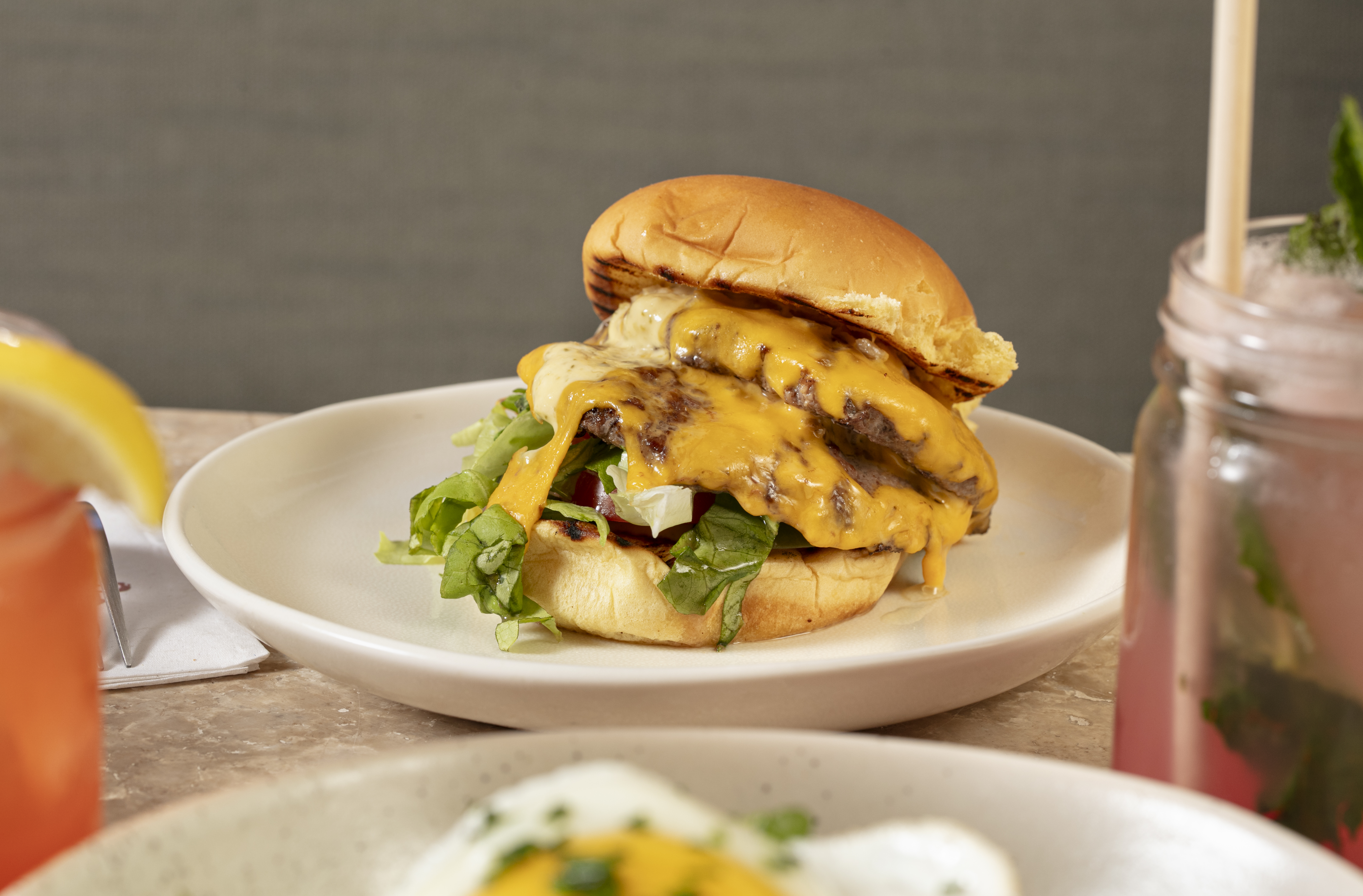 a sandwich sitting on top of a plate of food on a table