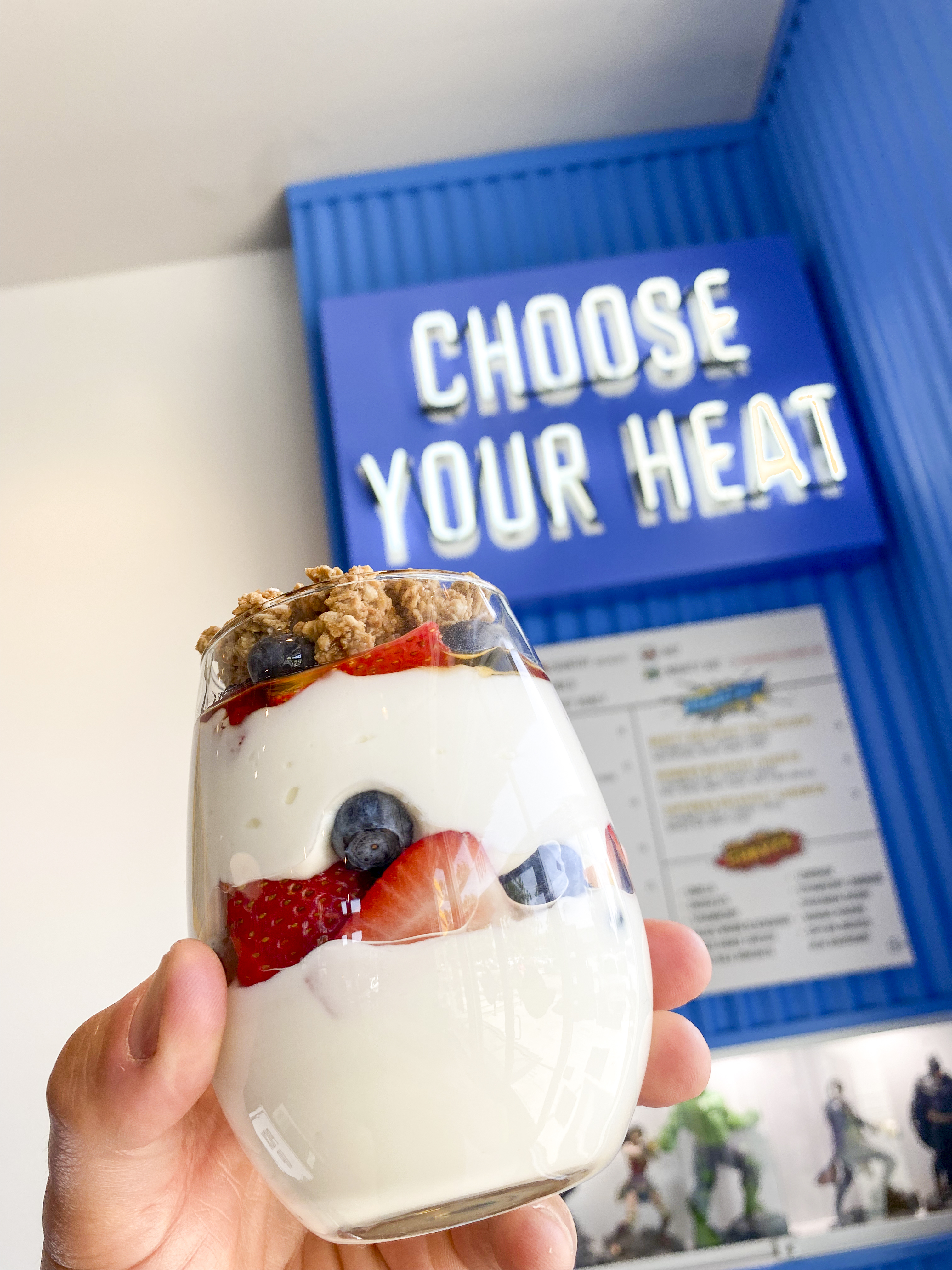 a close up of a person holding a parfait