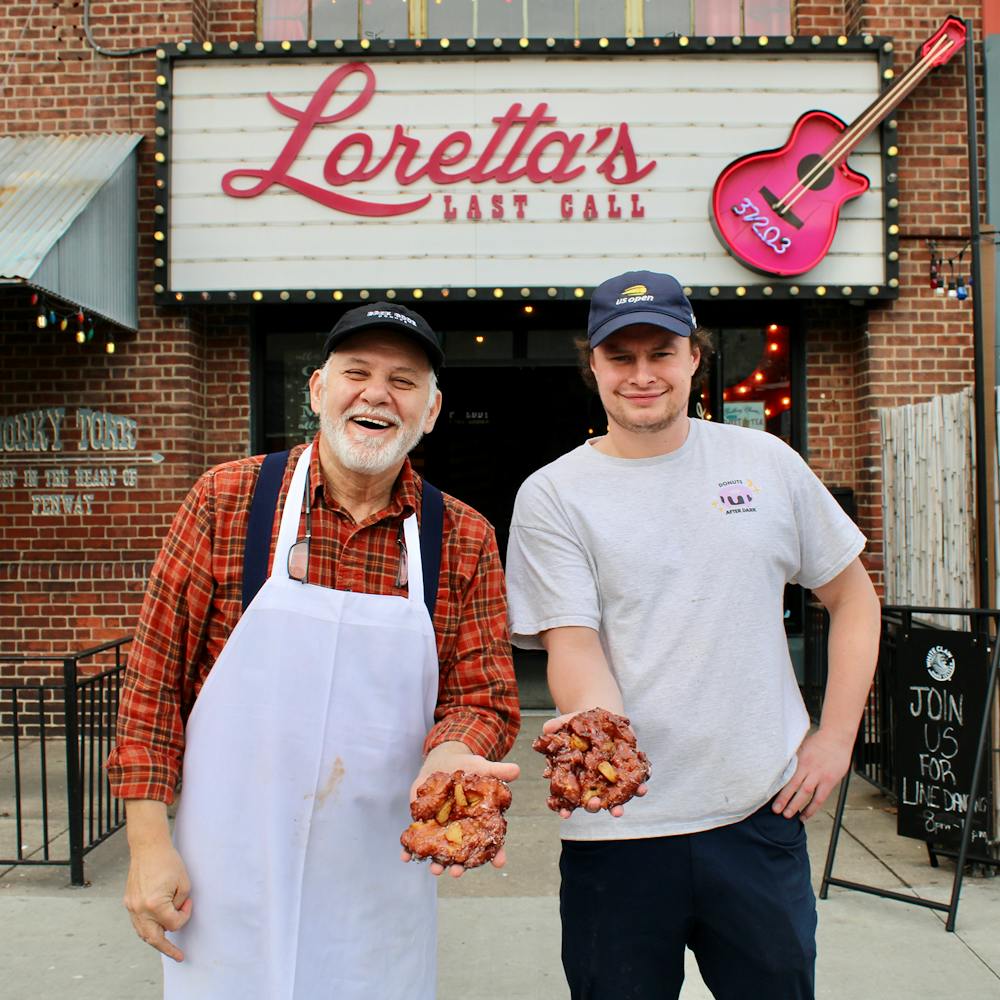a man and a woman posing in front of a building