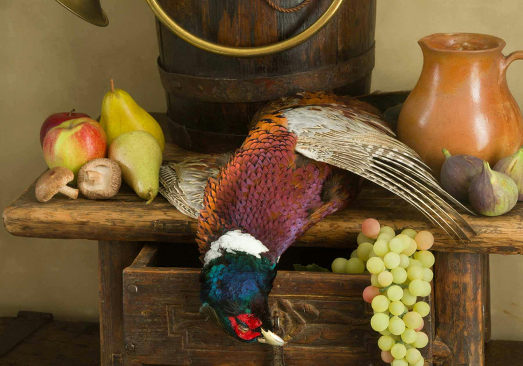 Table with wild game - pheasant and fresh produce.