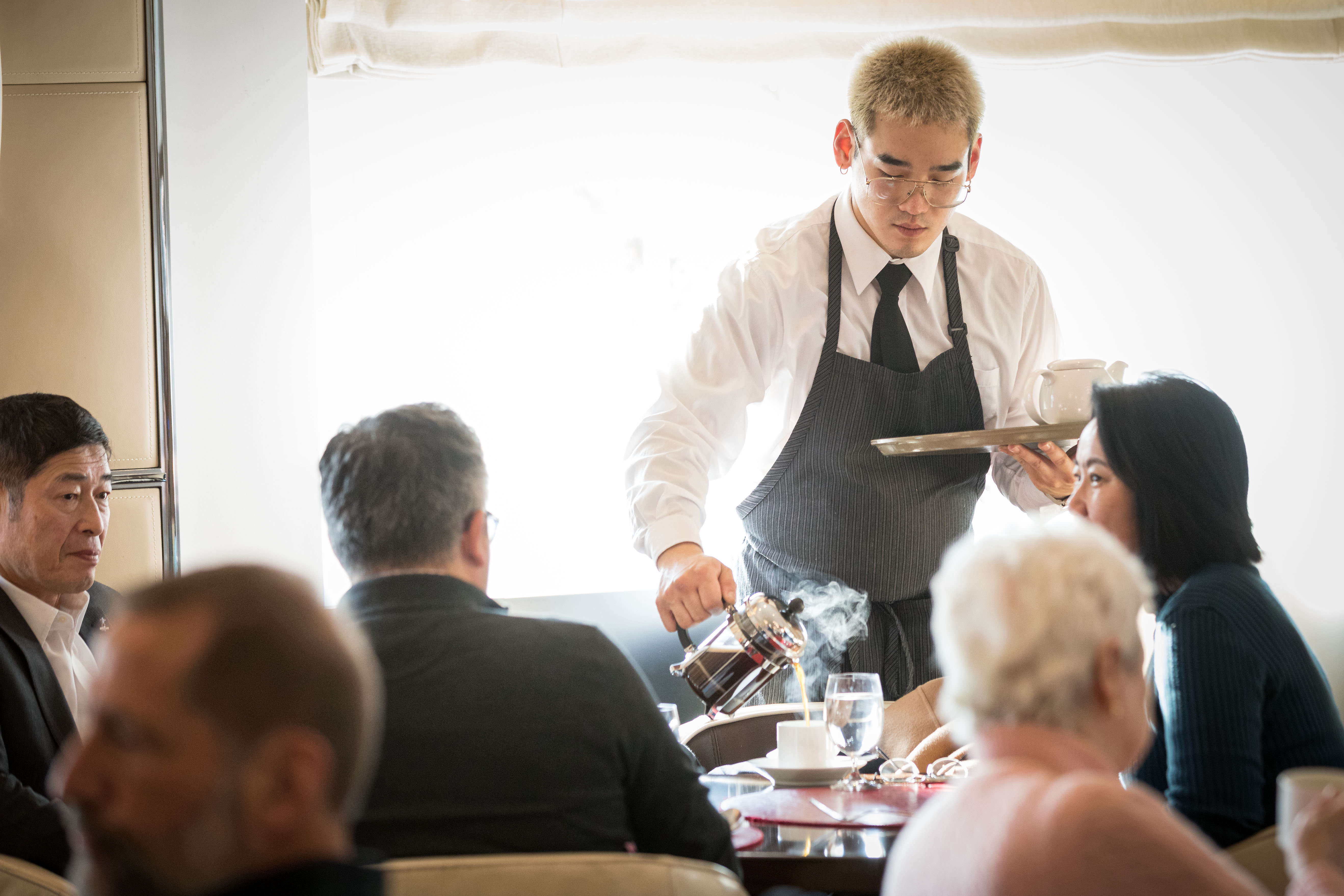 a waiter serving a group of people