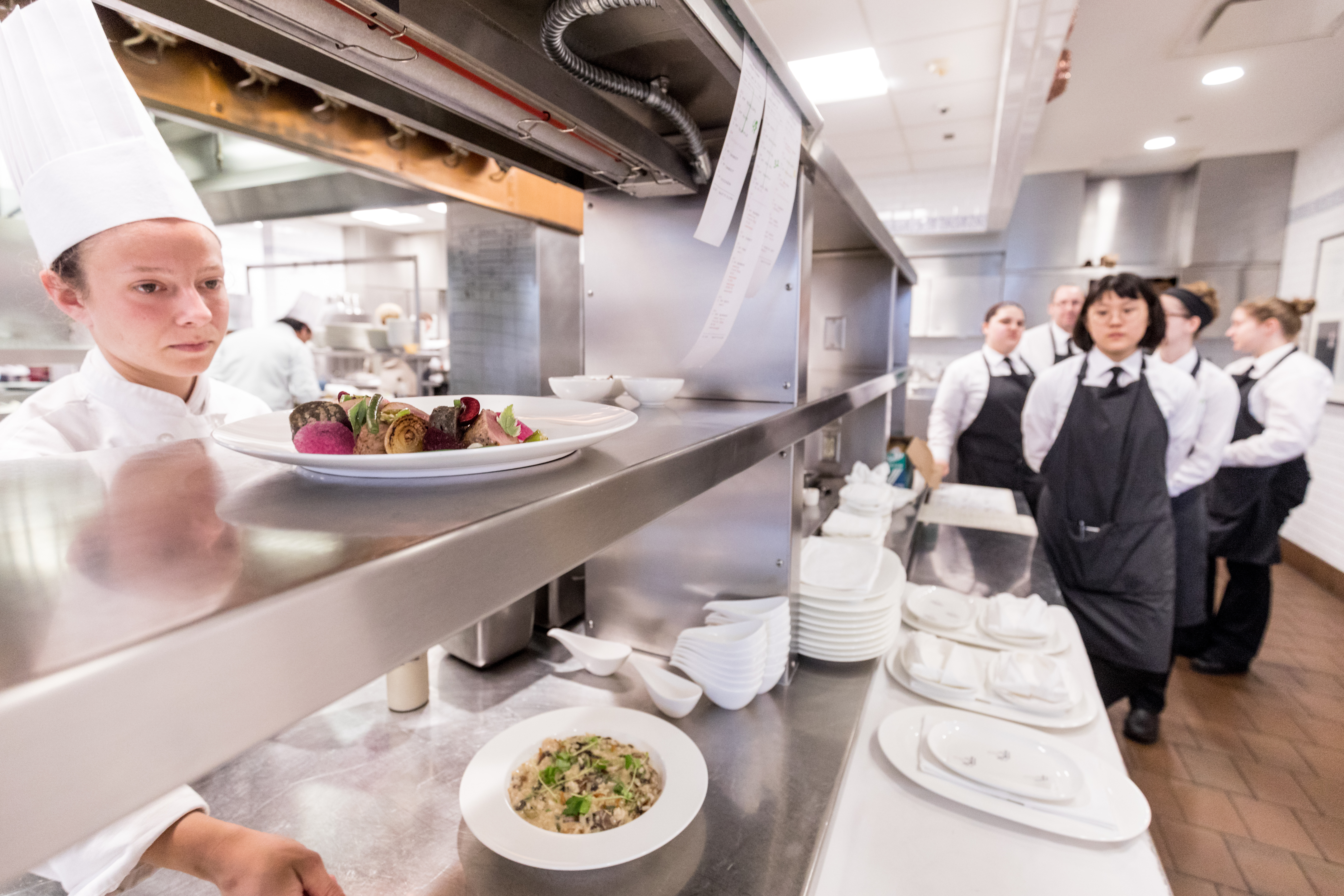 a group of people in a kitchen