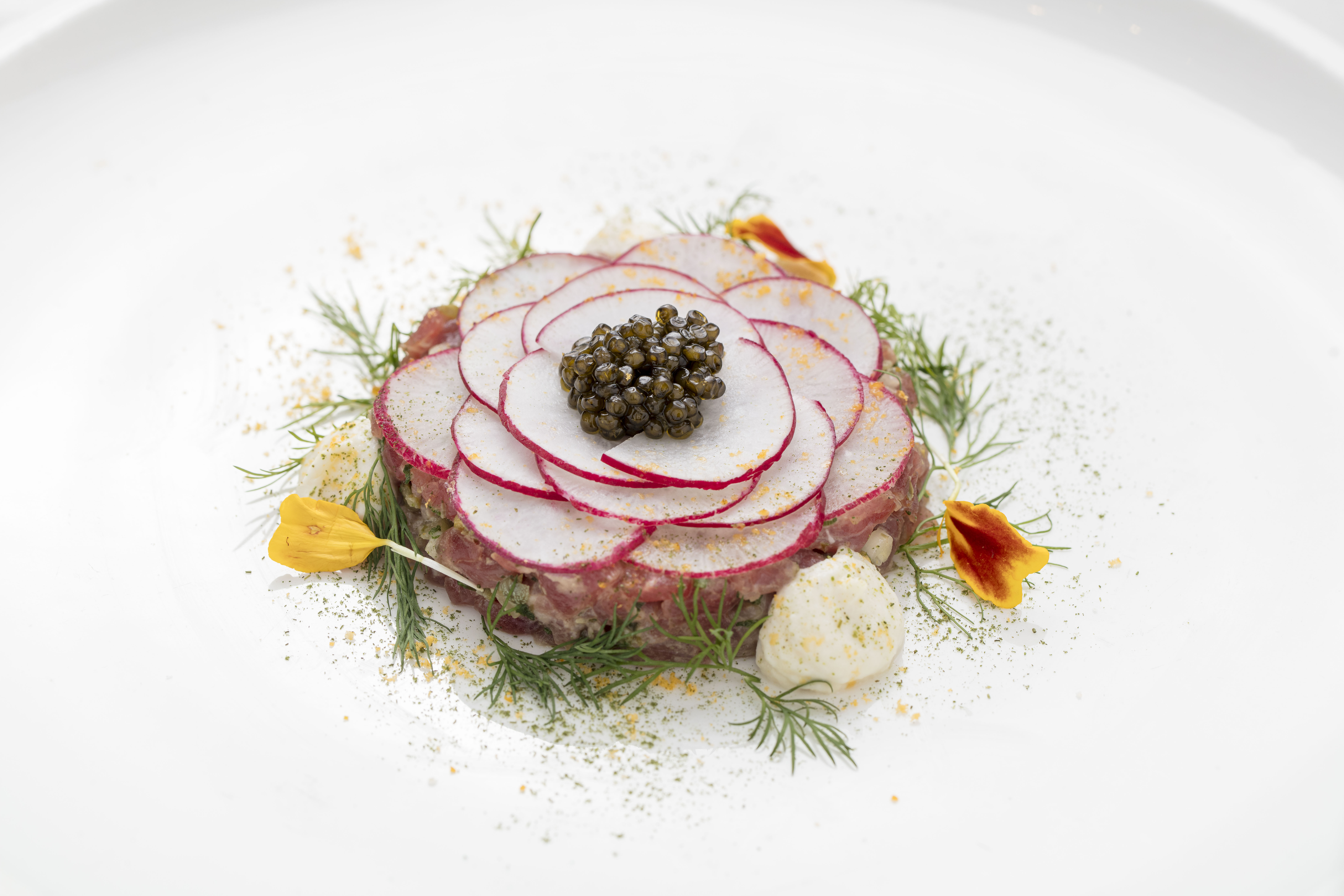 a plate of food with flowers and herbs