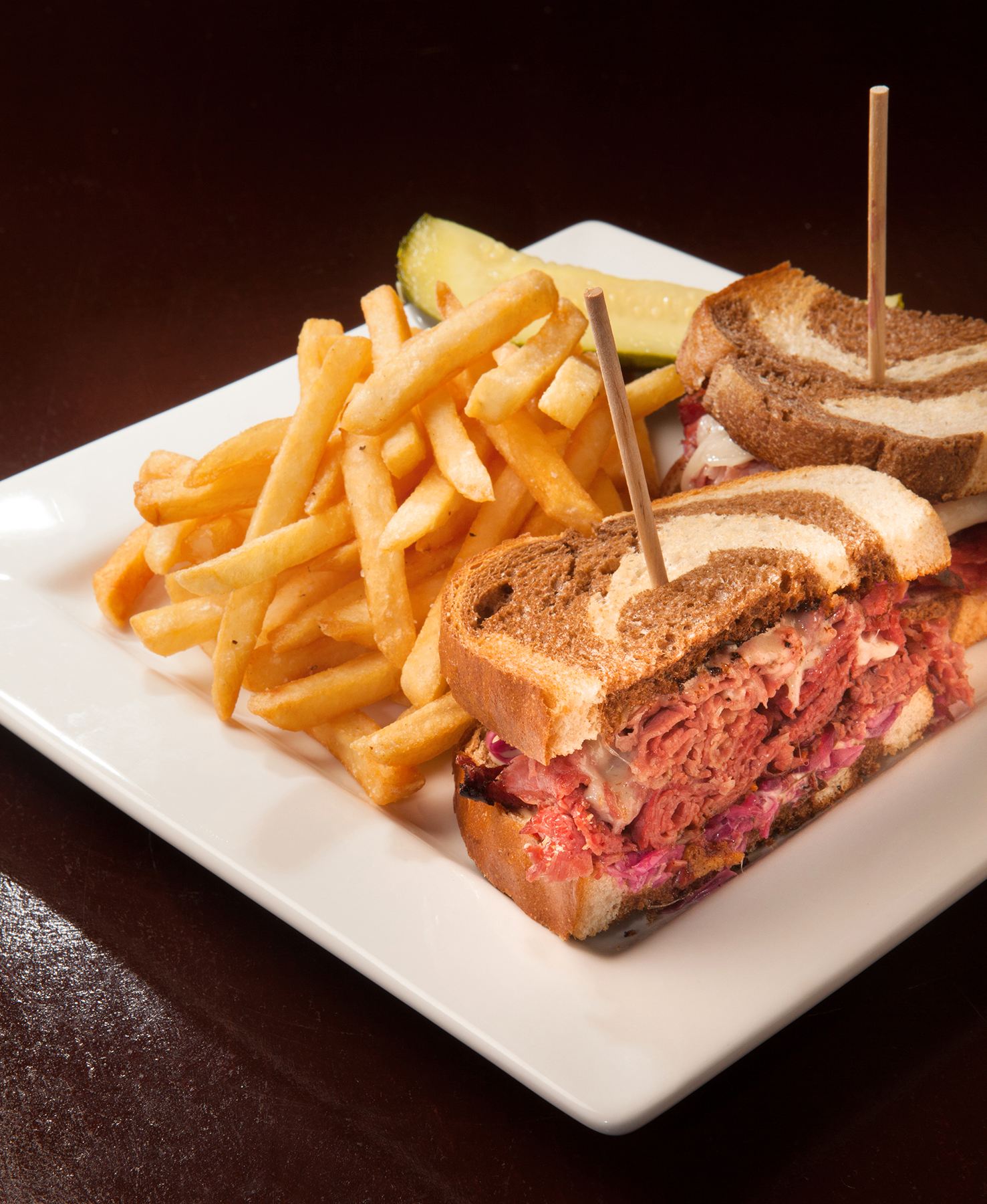 a close up of a sandwich and fries on a plate