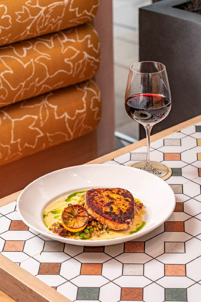 a plate of food and a glass of wine