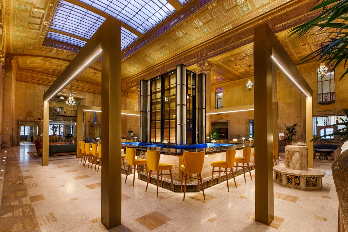 a large room with a bar and chairs