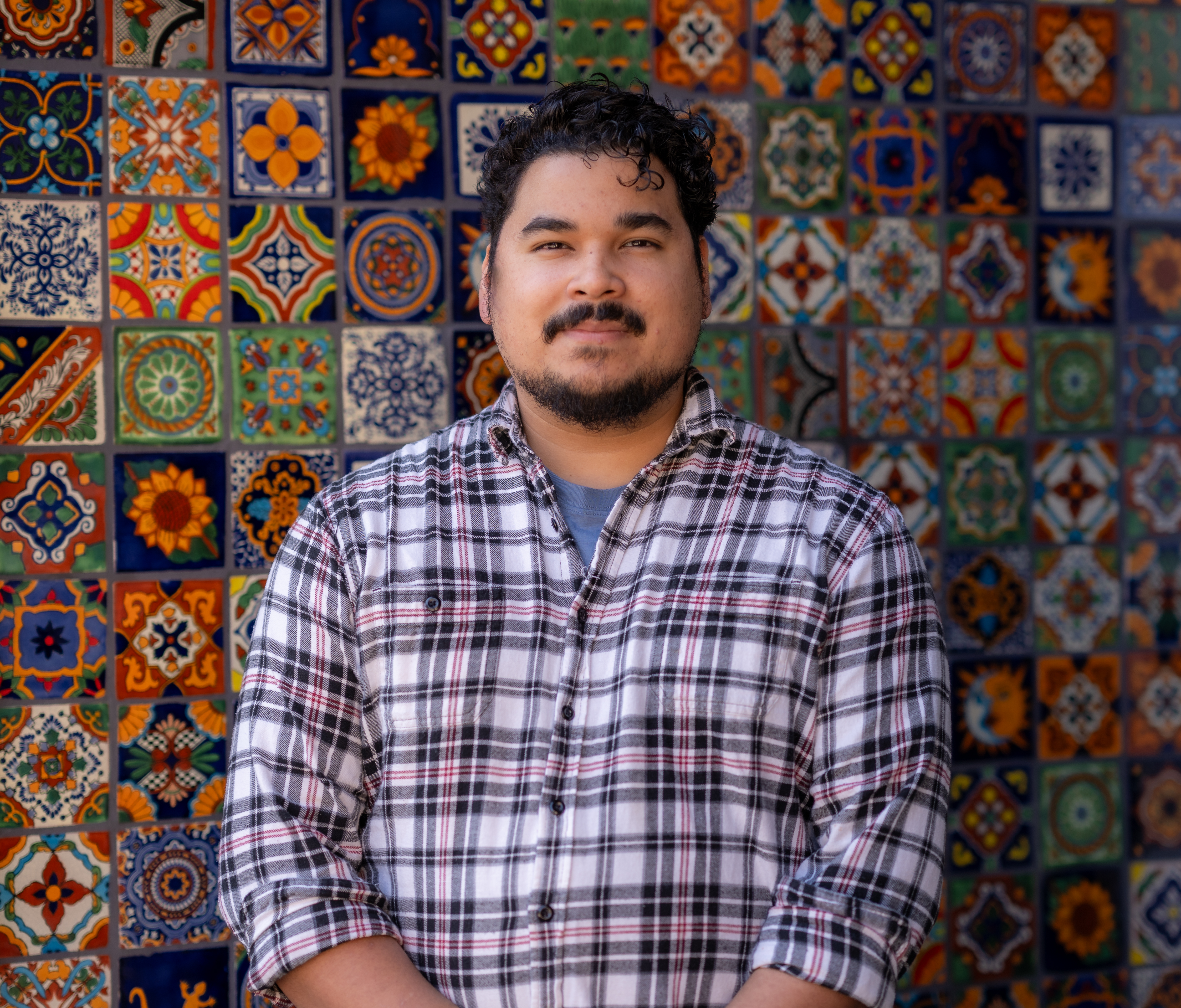 a man standing in front of a colorful wall