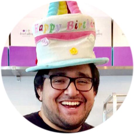 a man wearing a hat and smiling at the camera