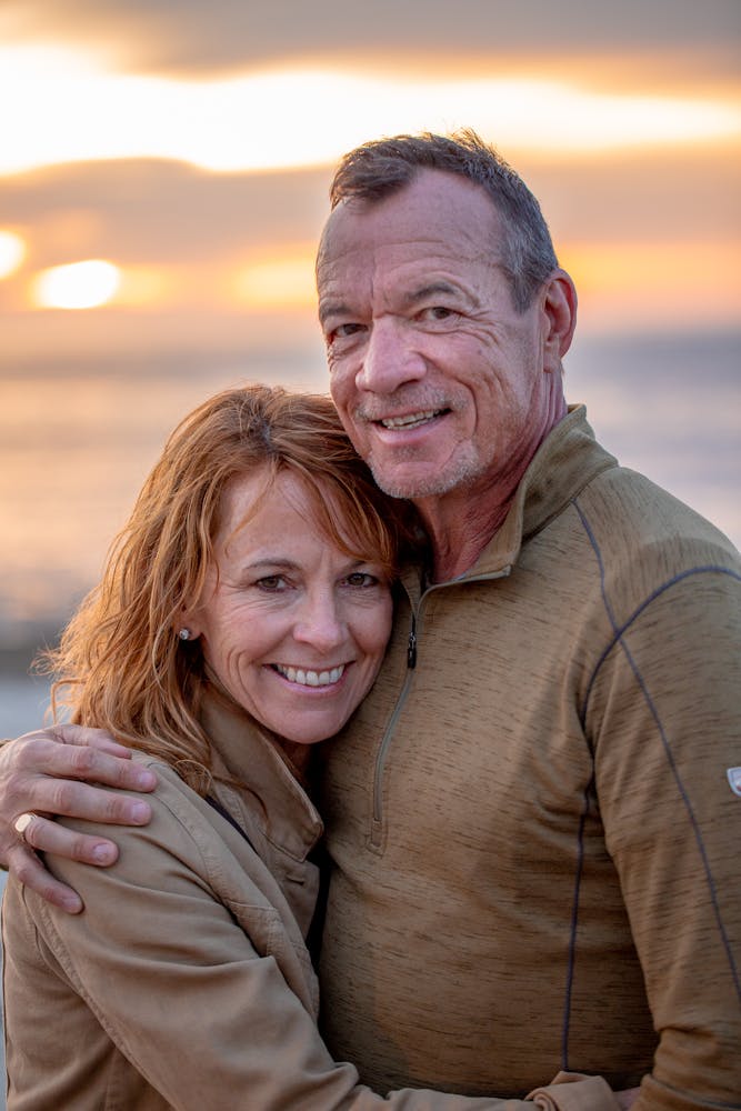 a man and a woman smiling for the camera