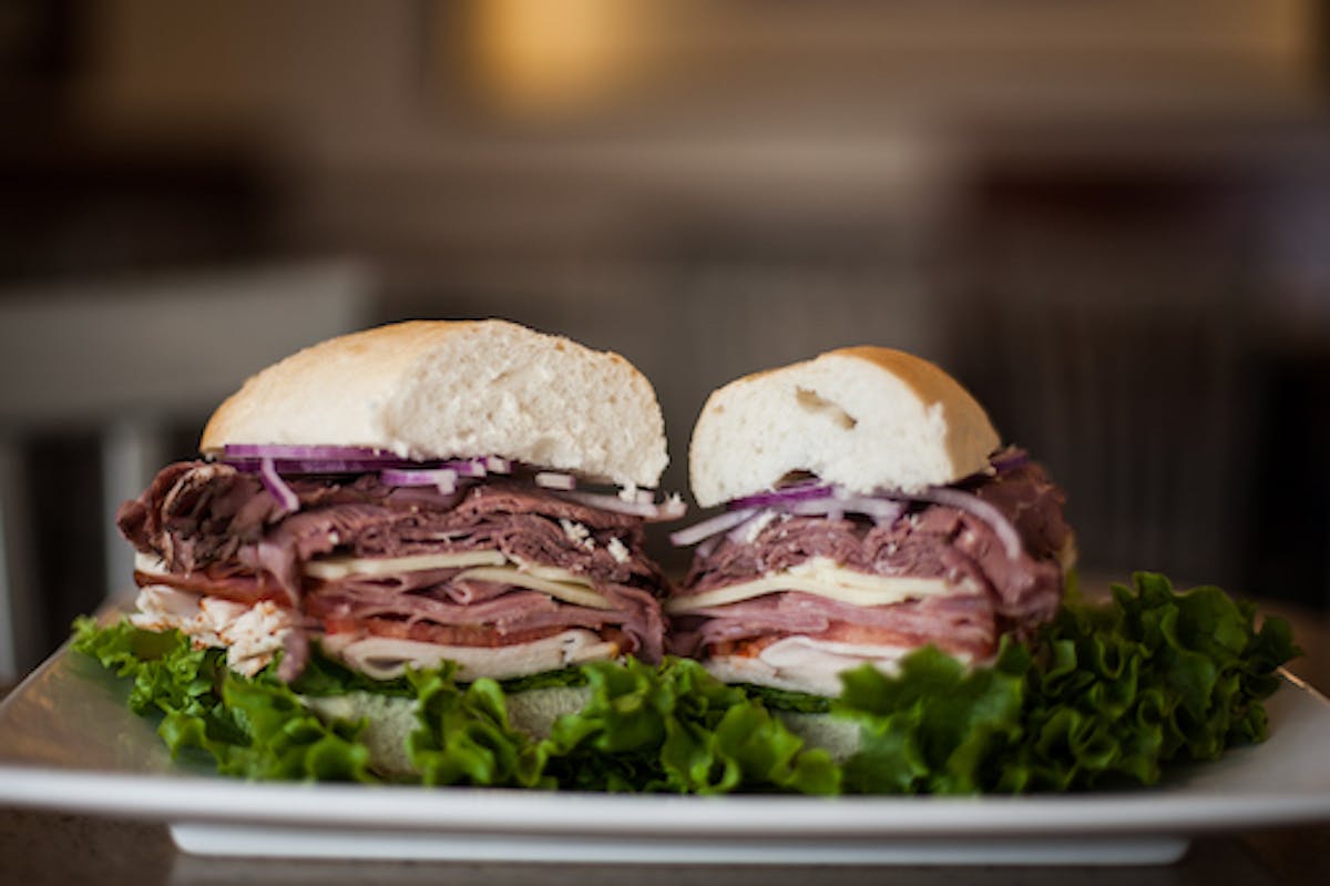 a close up of a plate of food with a sandwich and a salad