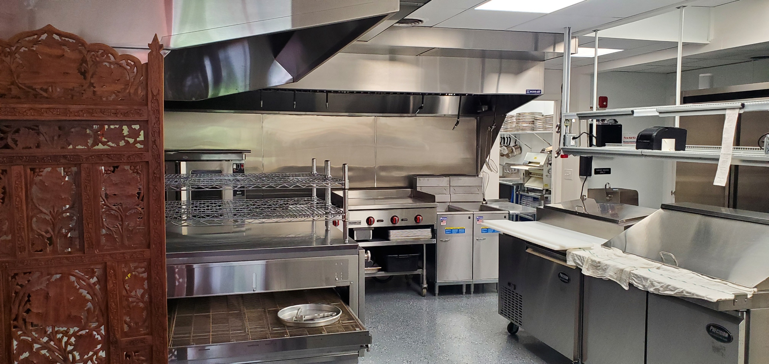 a stove top oven sitting inside of a kitchen