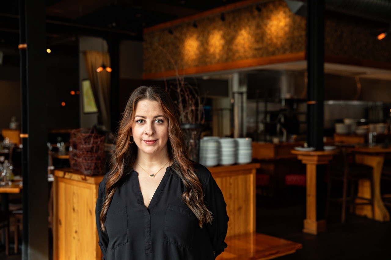 a woman standing in front of a restaurant