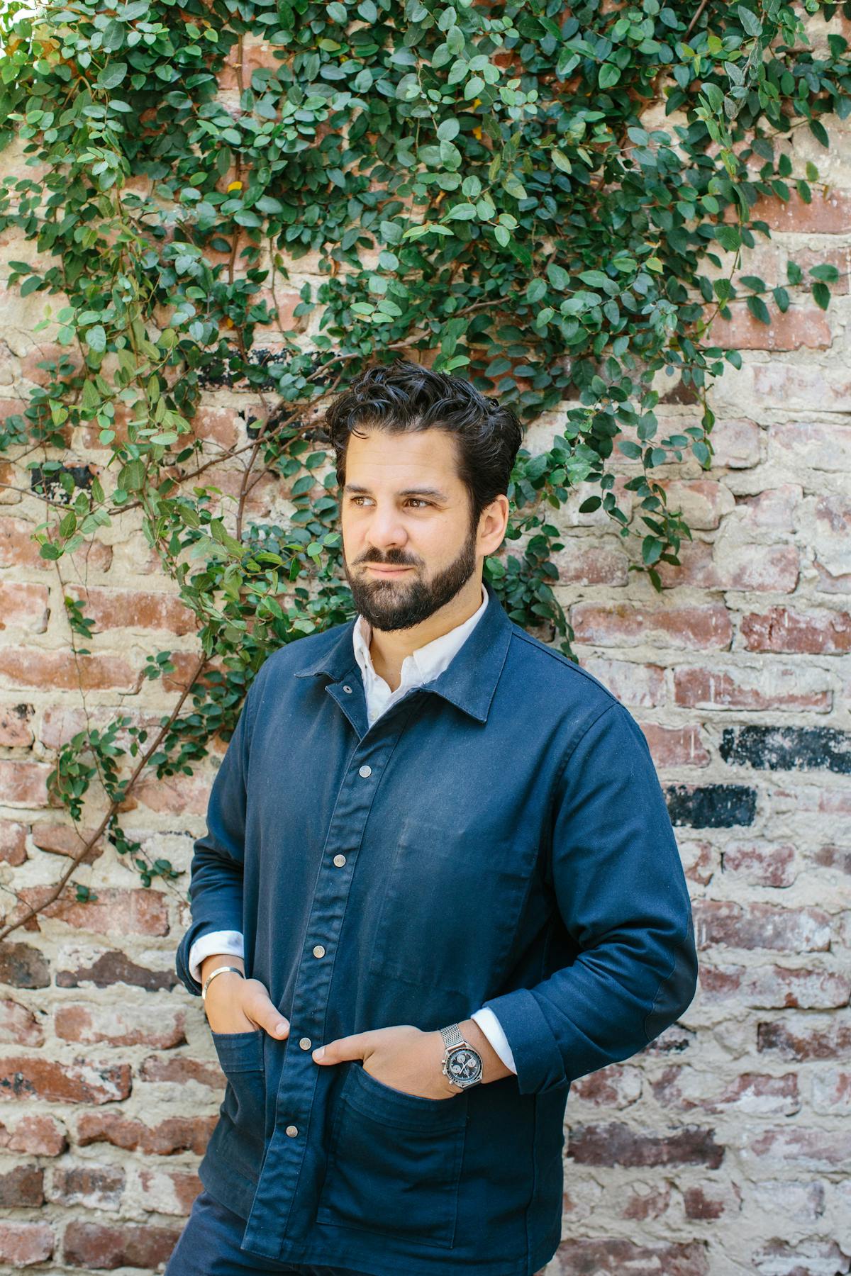 Charles Bililies standing in front of a brick wall