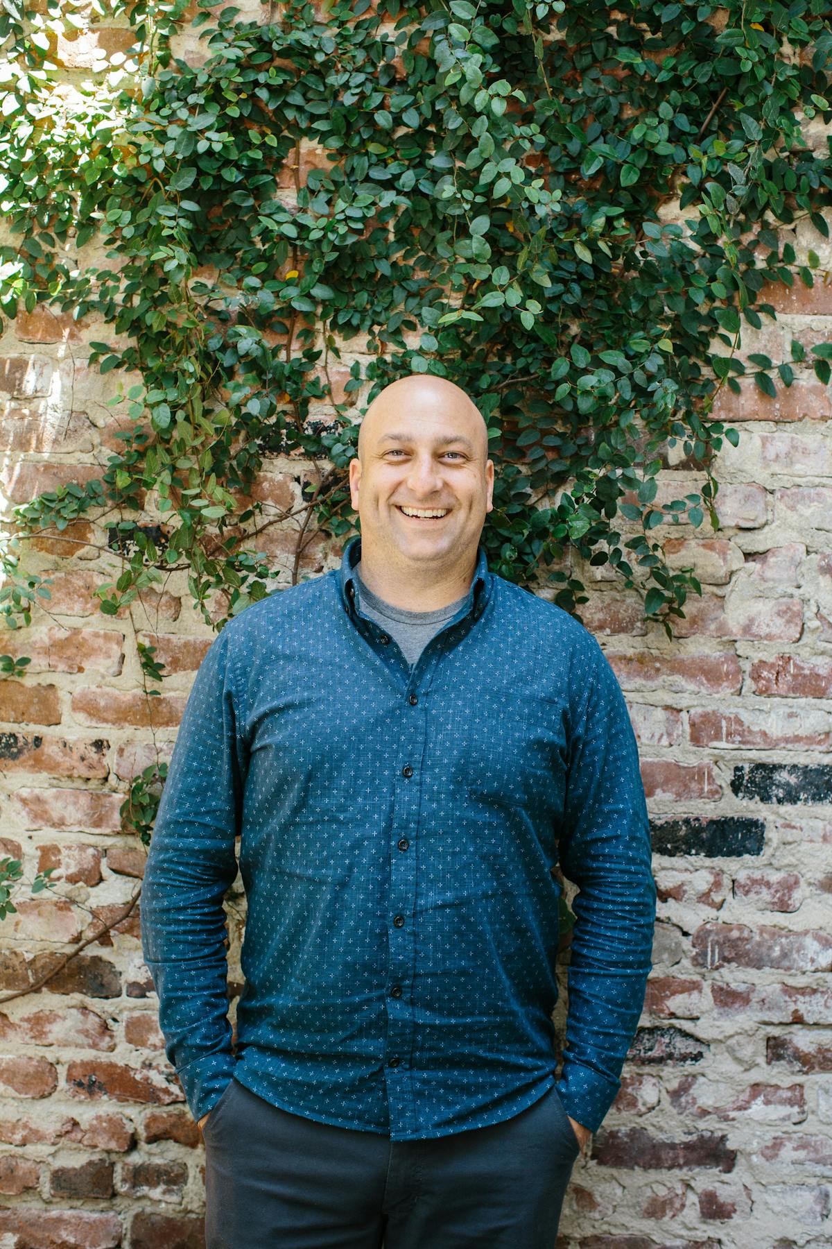 a person standing in front of a brick wall