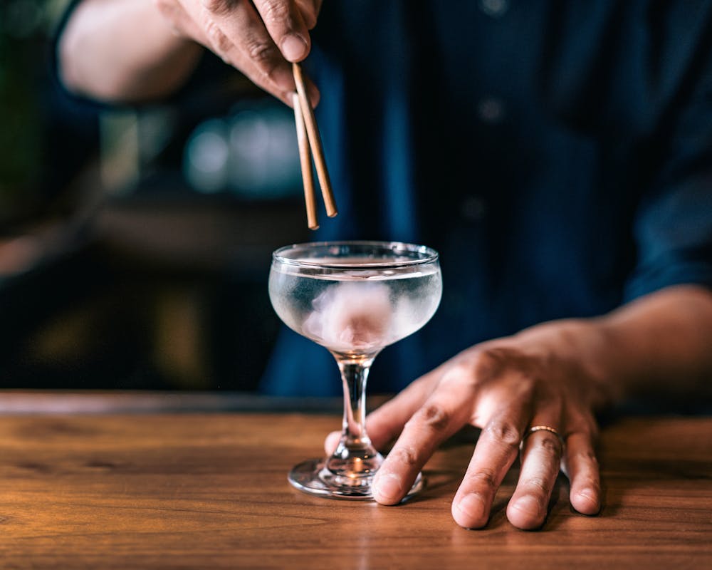 a hand holding a glass of wine