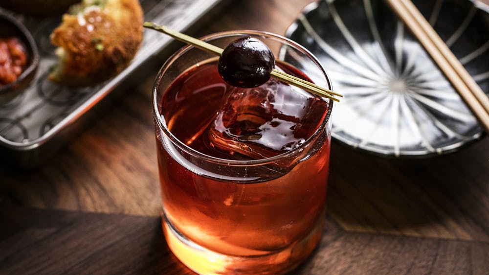 a cup of coffee sitting on top of a wooden table