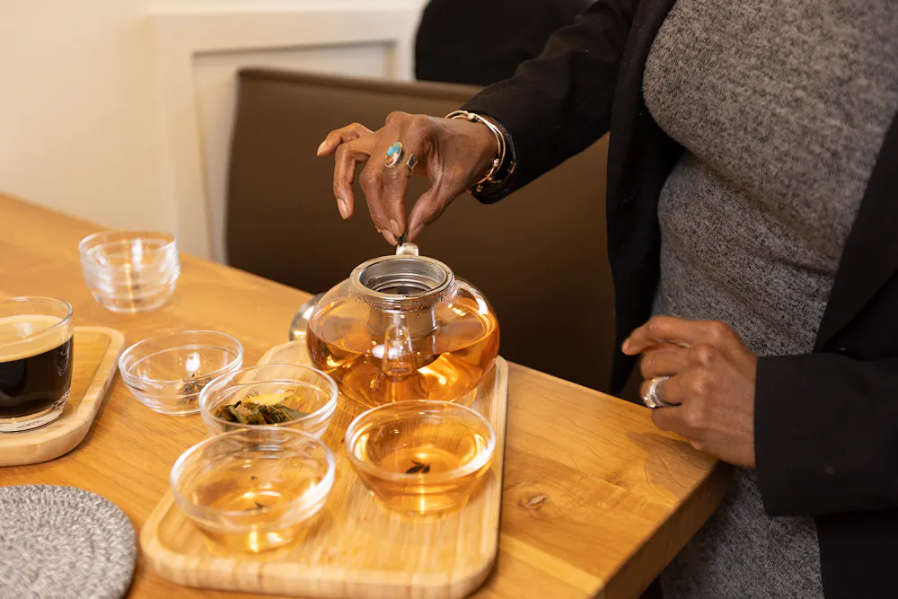 a person sitting at a table with wine glasses