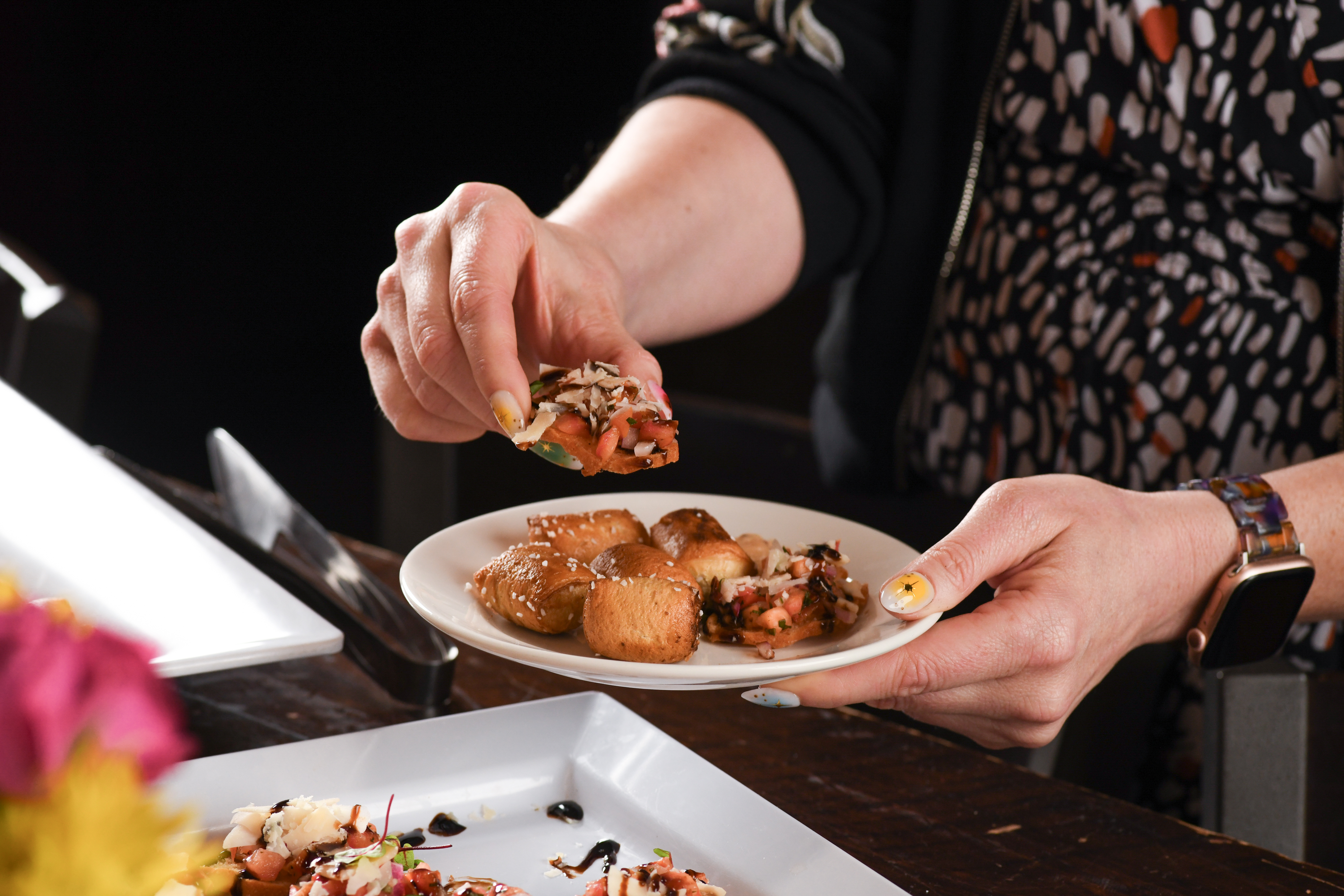 a woman sitting at a table with a plate of food