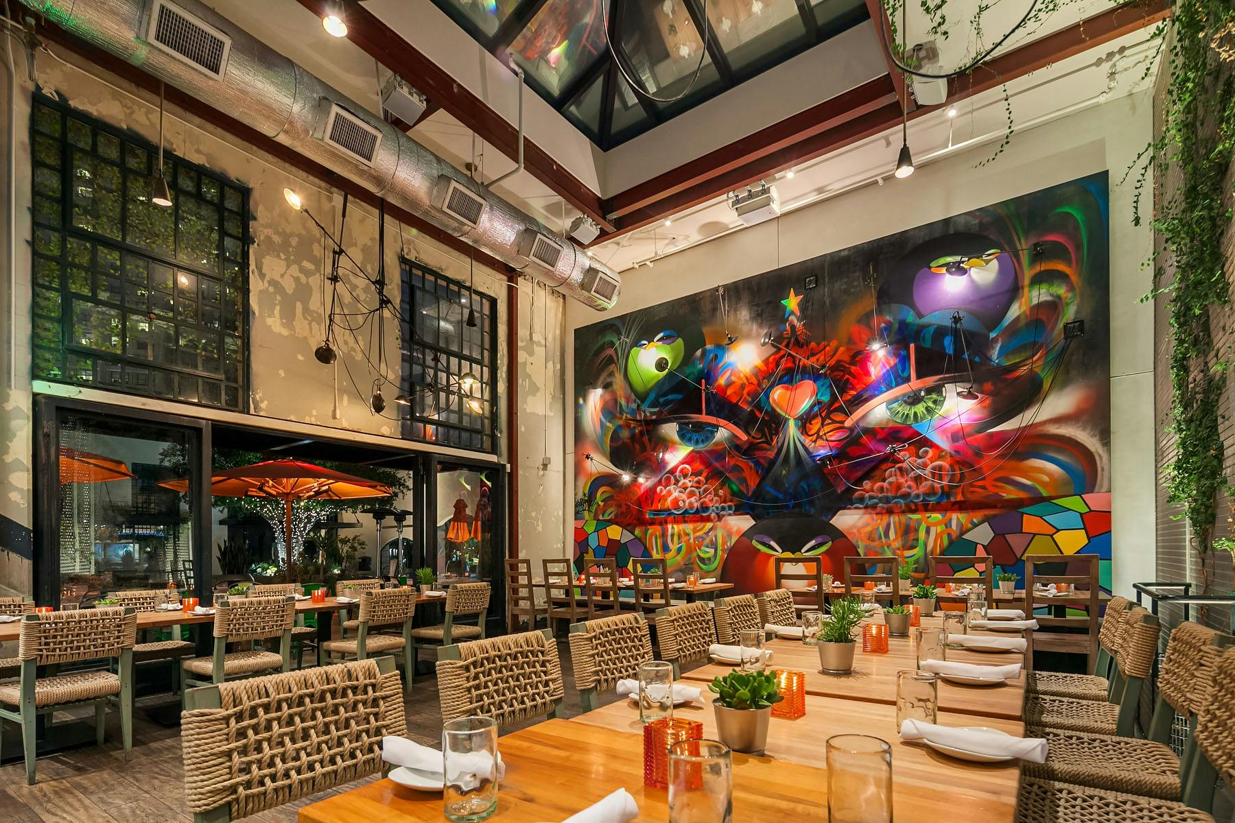 a restaurant dining room with a drawing as a background