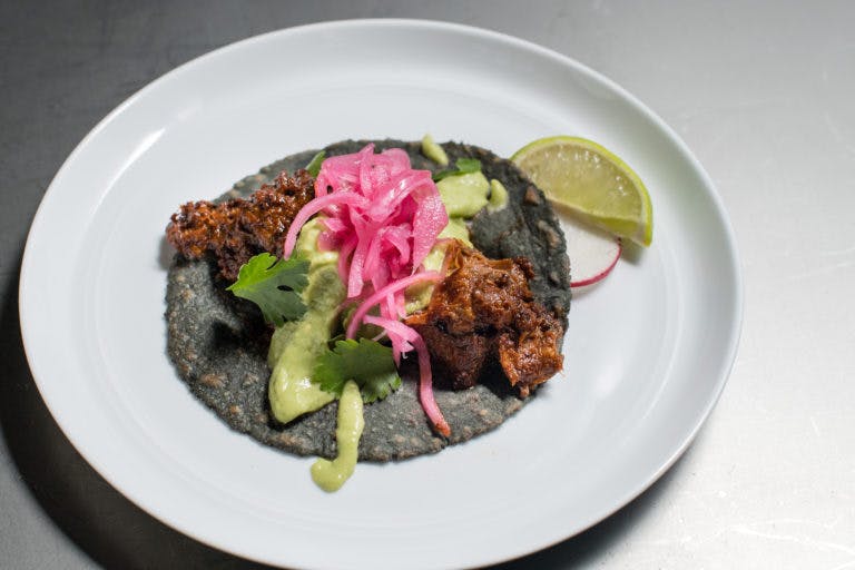 a blue tortilla taco on a plate