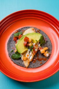 a blue tortilla taco on a plate