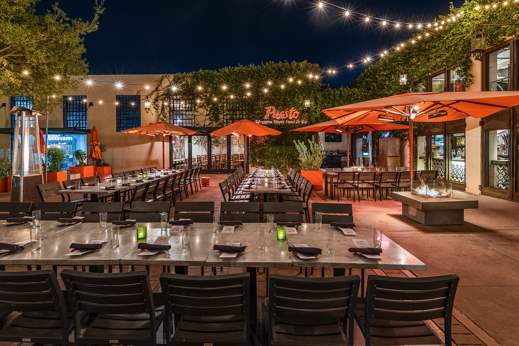 a group of people sitting at a table in front of a building