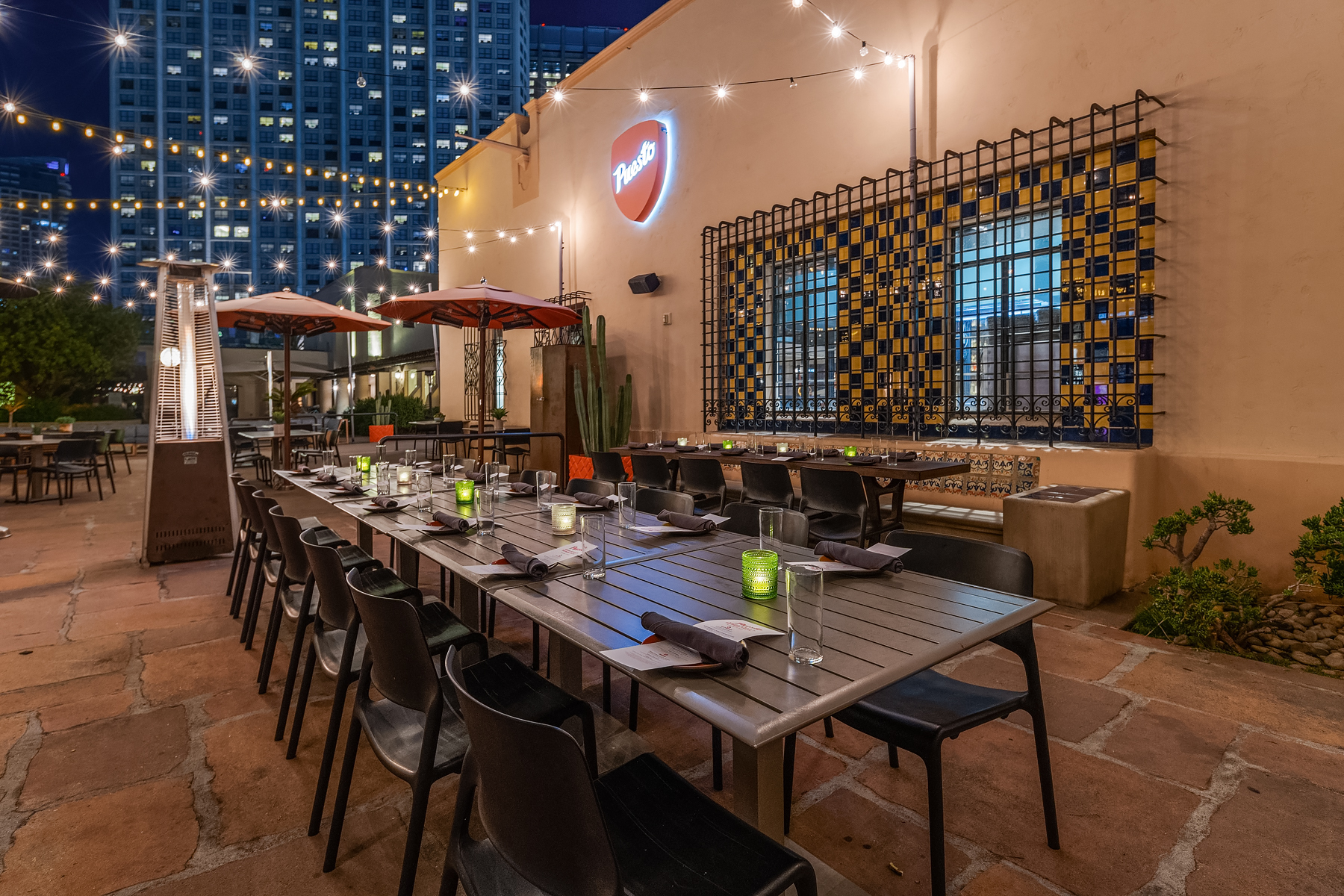 a group of men sitting at a table in front of a building