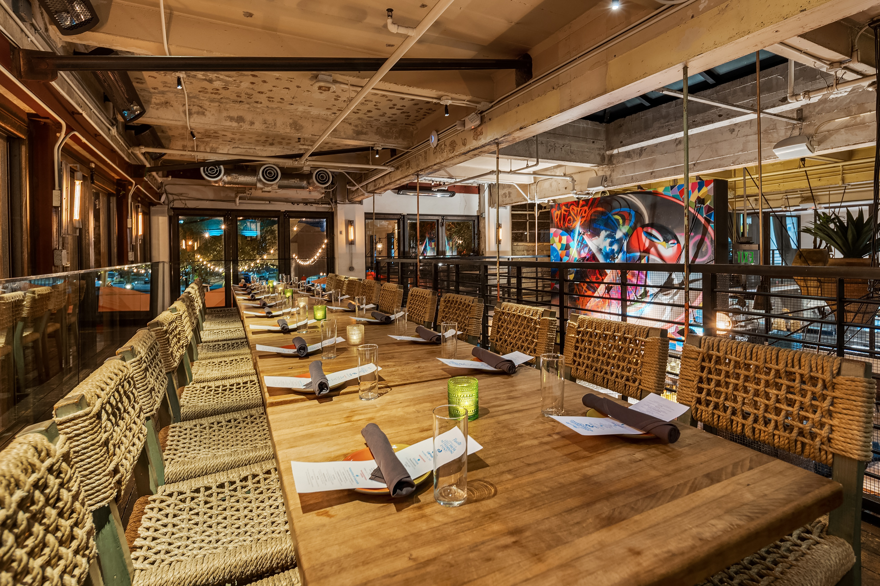 a room filled with furniture and a table in front of a building