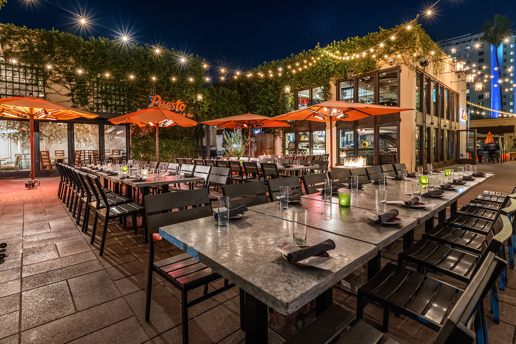a group of people sitting at a table in front of a building