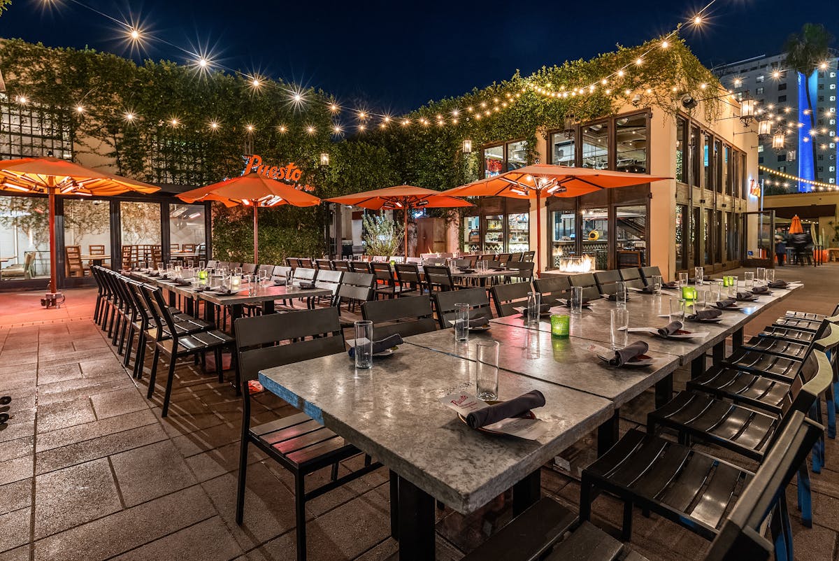 a group of people sitting at a table in front of a building