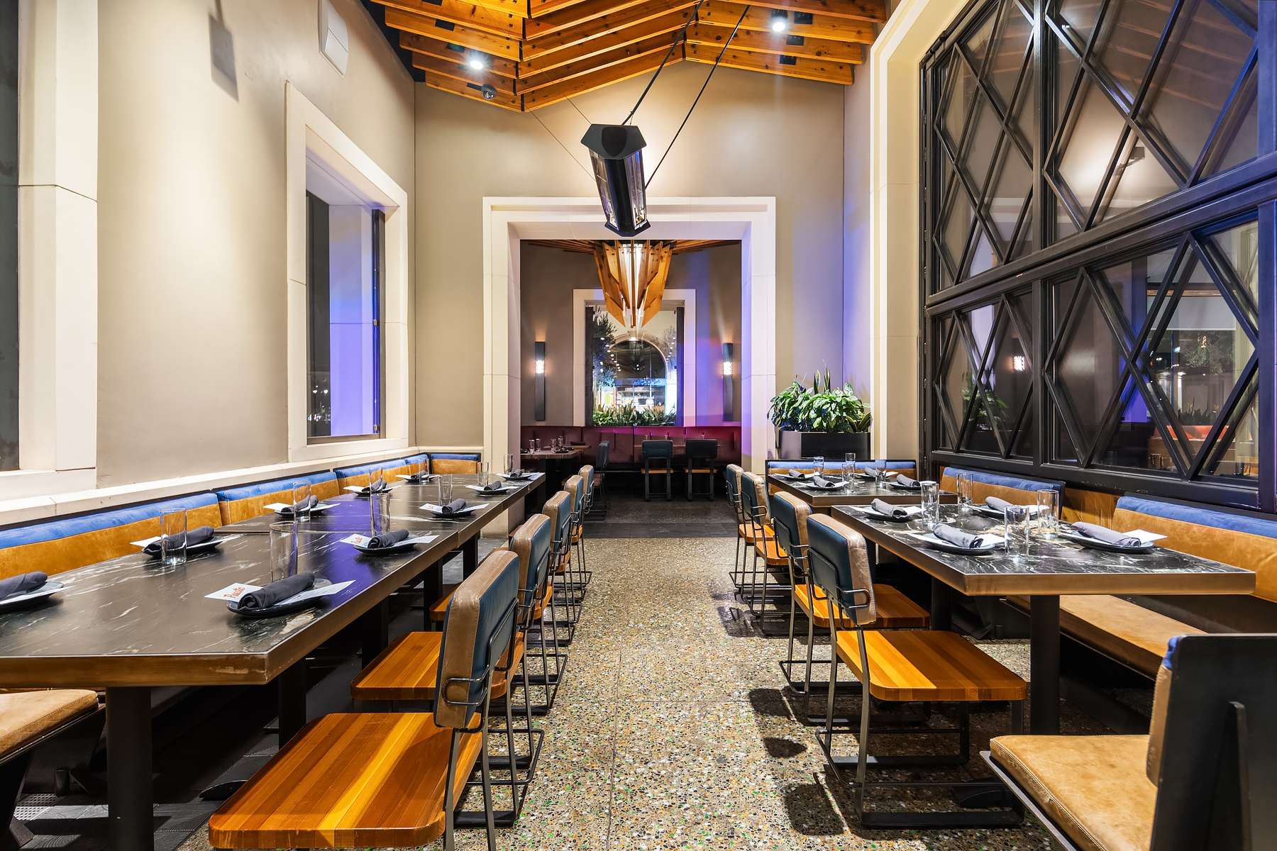 a group of people sitting at a table in front of a building